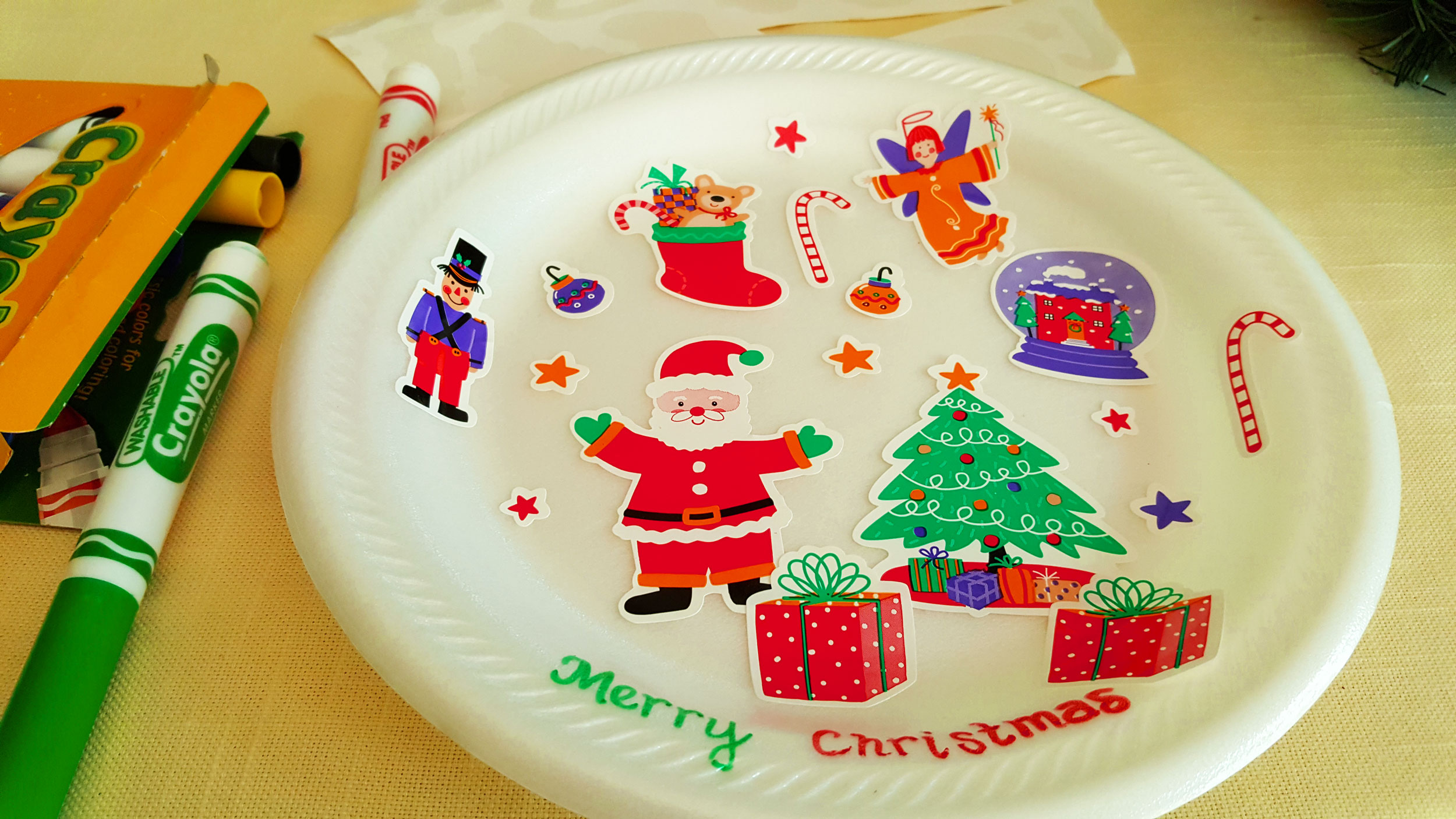 Step 1 of the DIY Holiday Wreath is to optionally color in the plates, draw pictures of Santa and other holiday figures on the plates, or use stickers to decorate the plates. | OrnamentShop.com