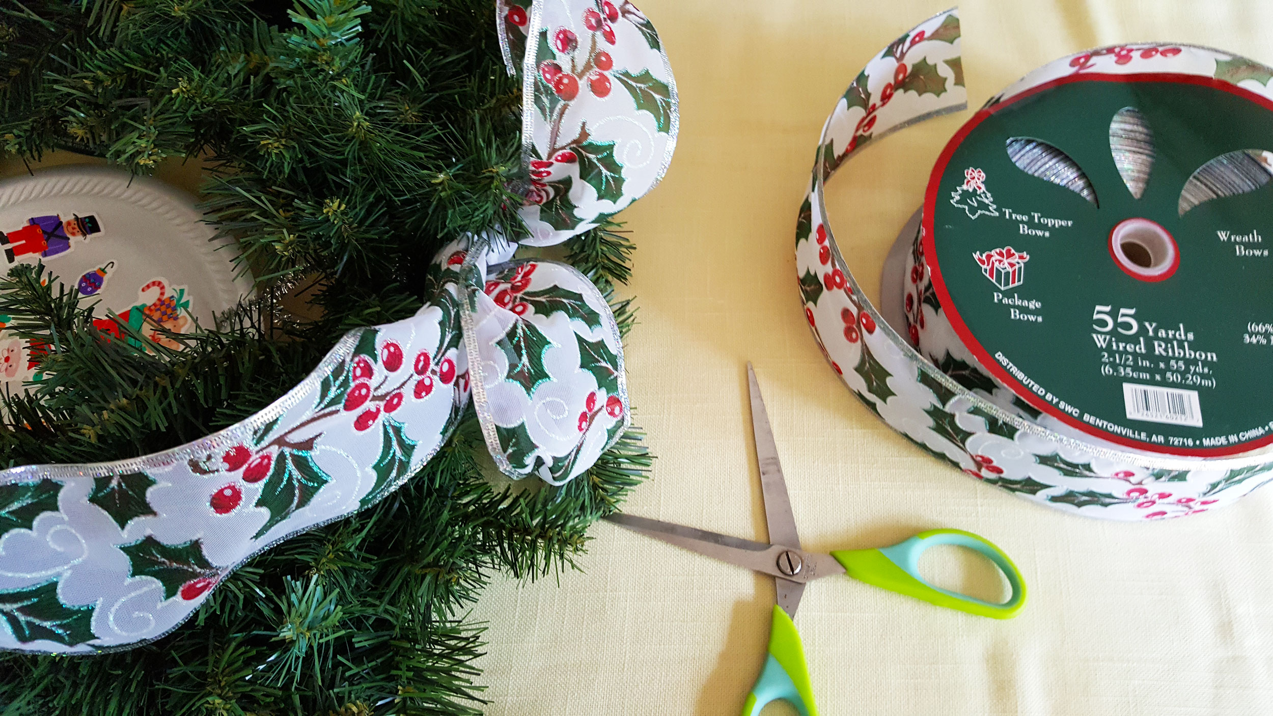 Step 4 is to tie a long piece of ribbon into a bow around the top of the greenery and let it dangle. | OrnamentShop.com