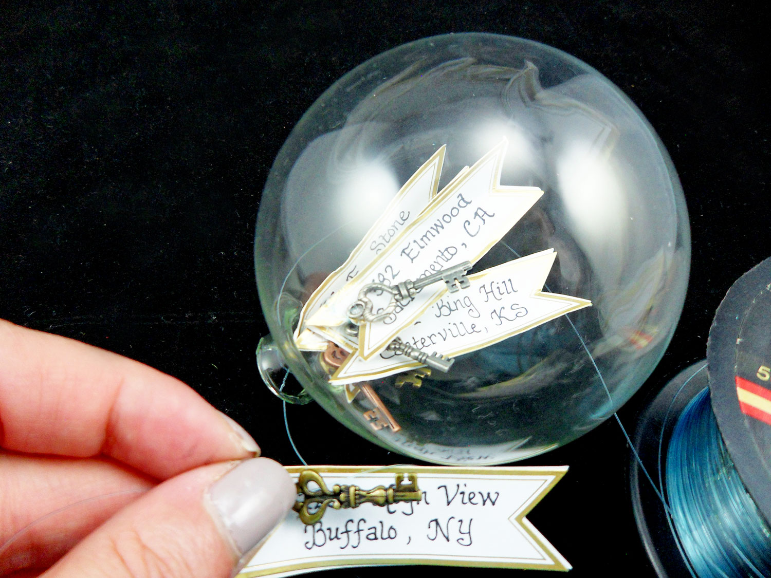 Keys And Address Tags Placed In Clear Ornament Ball | OrnamentShop.com