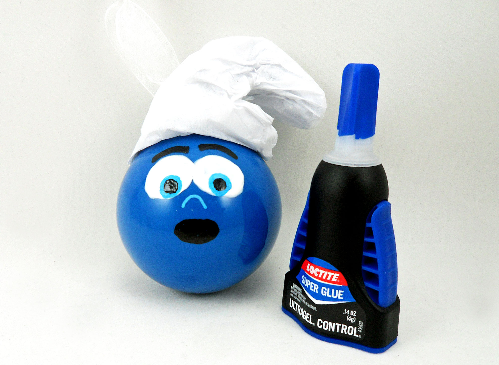 DIY Smurf ornament with hat next to glue | Ornament Shop