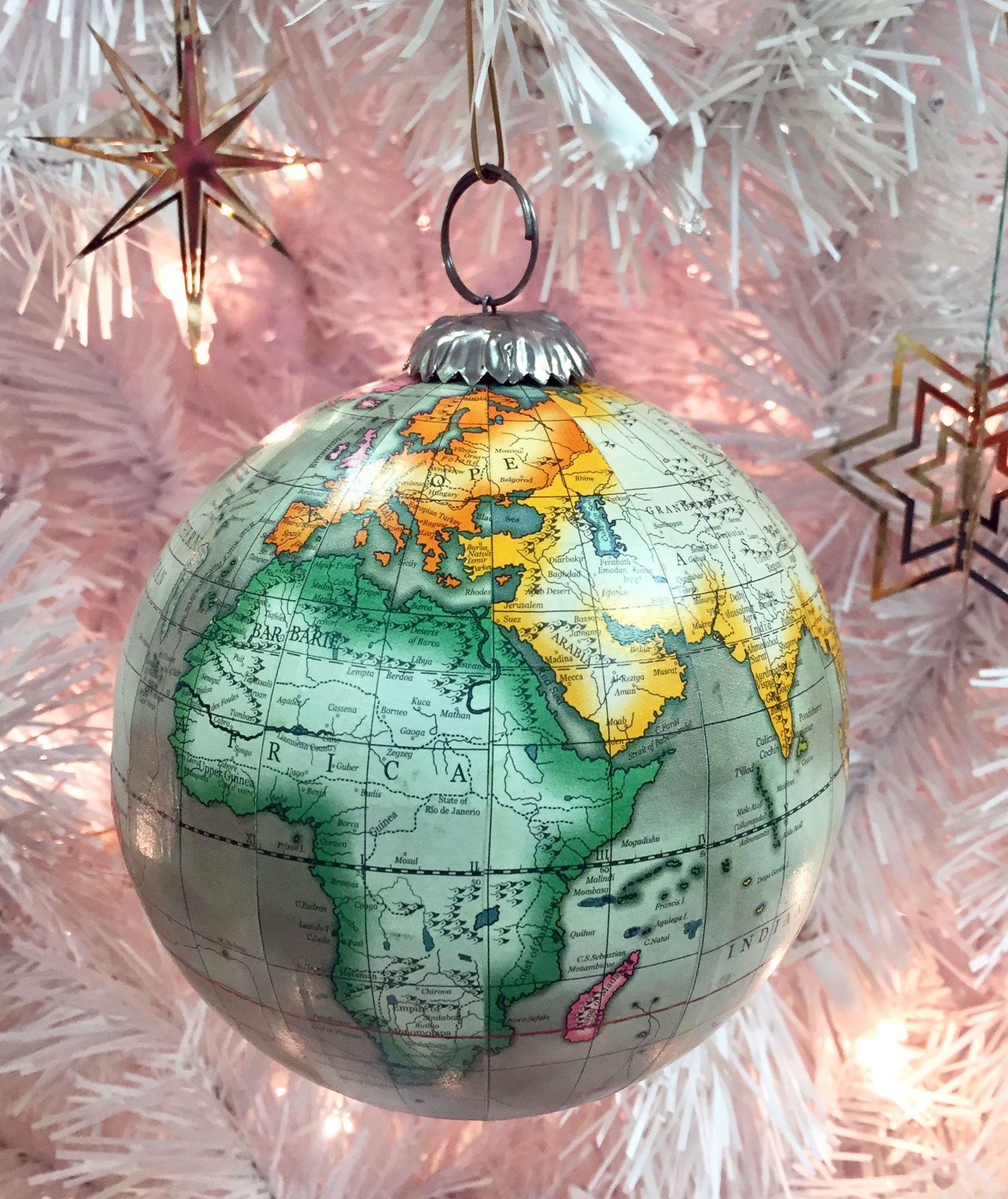 A globe ornament with a detailed world map, and two German gold star ornaments | OrnamentShop.com