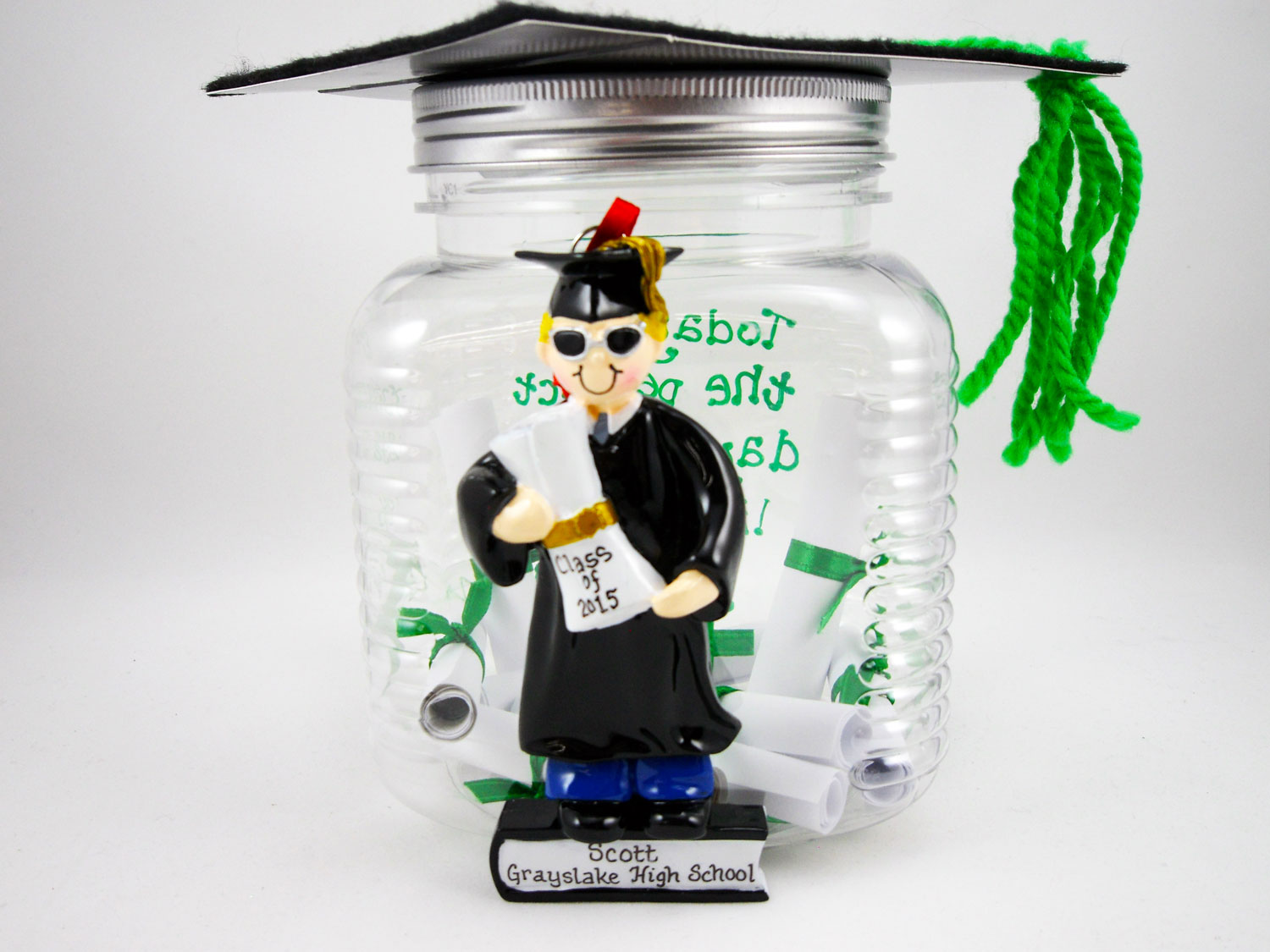 A creative money jar gift with rolled up dollar bills as diplomas and a personalized ornament glued to the front. Learn to make it yourself | OrnamentShop.com