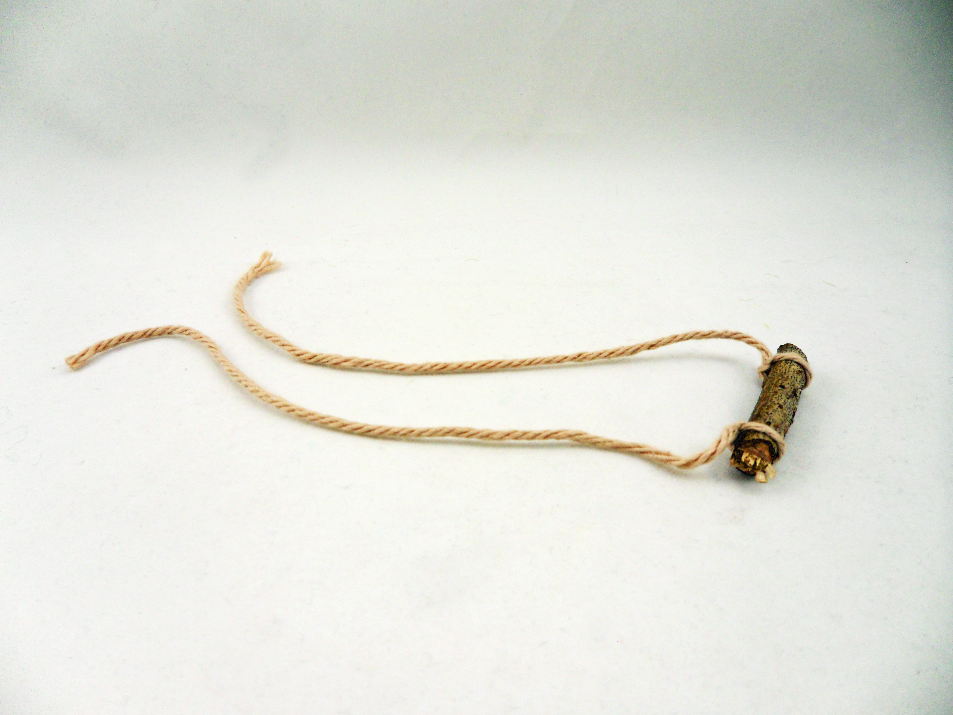 Step 5 is to create your perch by tying strands of string to a small piece of wood | OrnamentShop.com