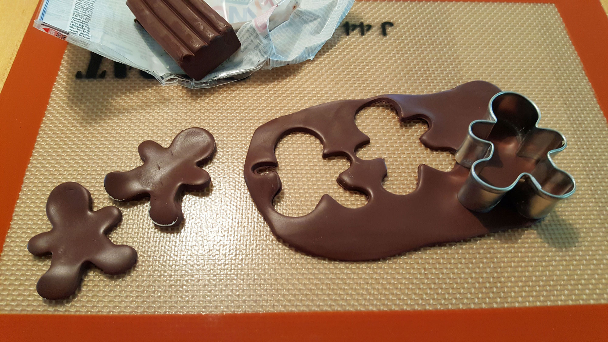 Step 2 is to use your gingerbread man cookie cutters to punch out your gingerbread people. Feel free to move the arms and legs into fun positions | OrnamentShop.com