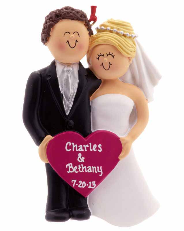 An ornament of a wedding couple, the bride blonde and the groom brunette, with a personalized pink heart in the middle | OrnamentShop.com