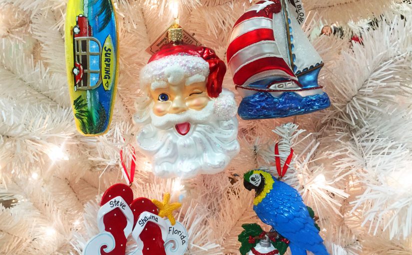 An assortment of summer-themed ornaments, including a sailboat, parrot, flipflops, surfboard and a winking Santa | OrnamentShop.com