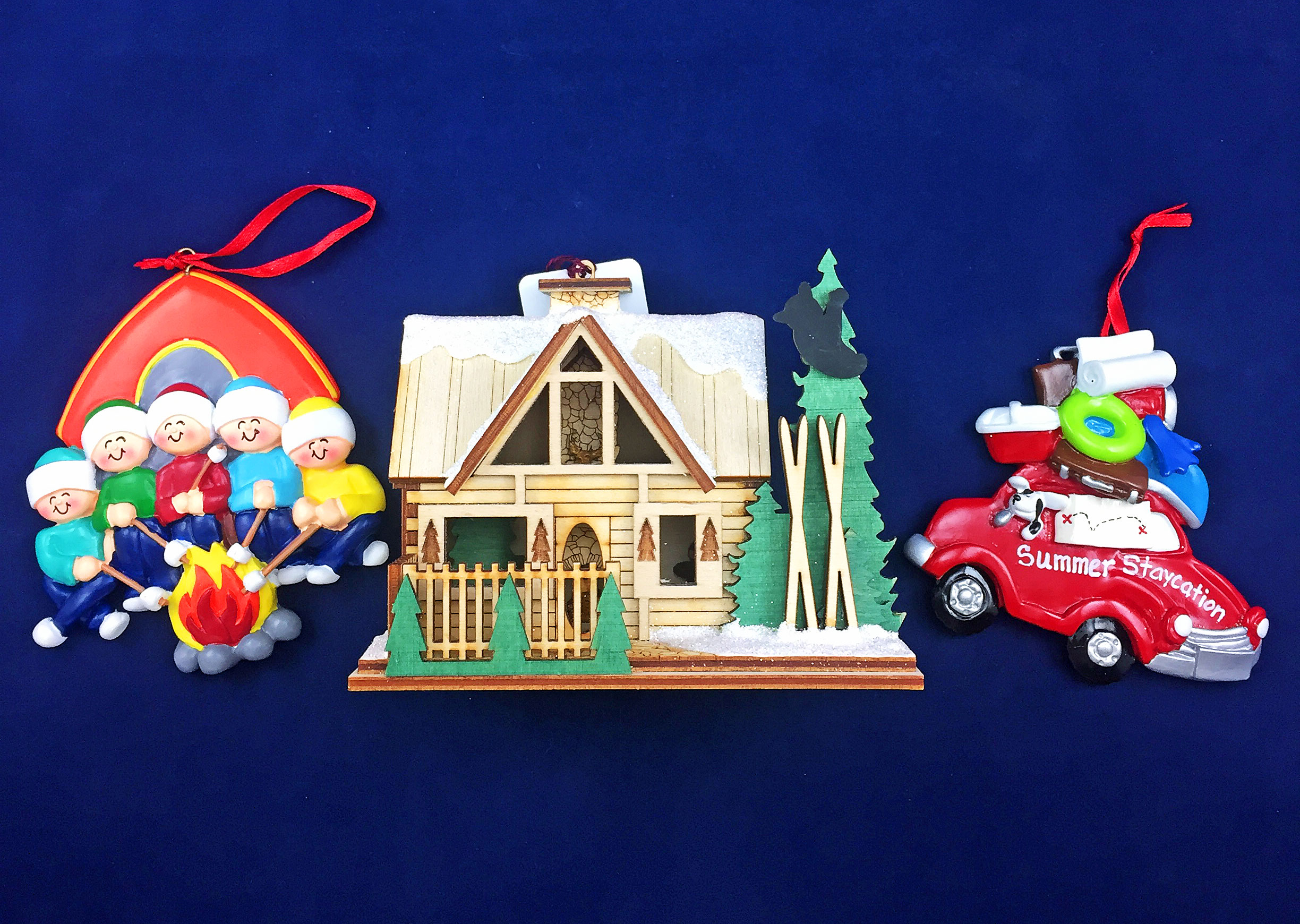 Three ornaments with a family of campers, a packed car heading to the beach and a ski lodge resort. | OrnamentShop.com