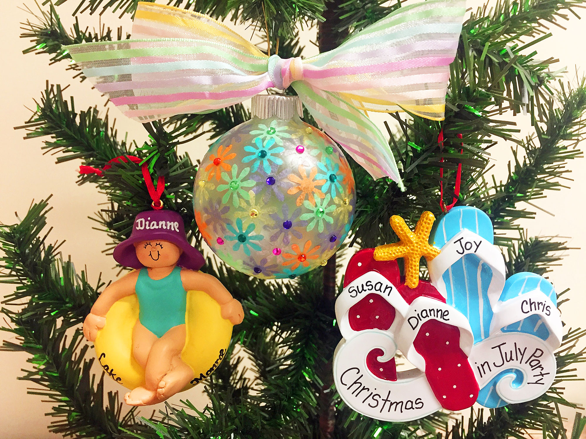 A colorful DIY ball ornament, an ornament with personalzied flipflops, and an ornament with a woman floating in a simming doughnut wearing a purple hat | OrnamentShop.com