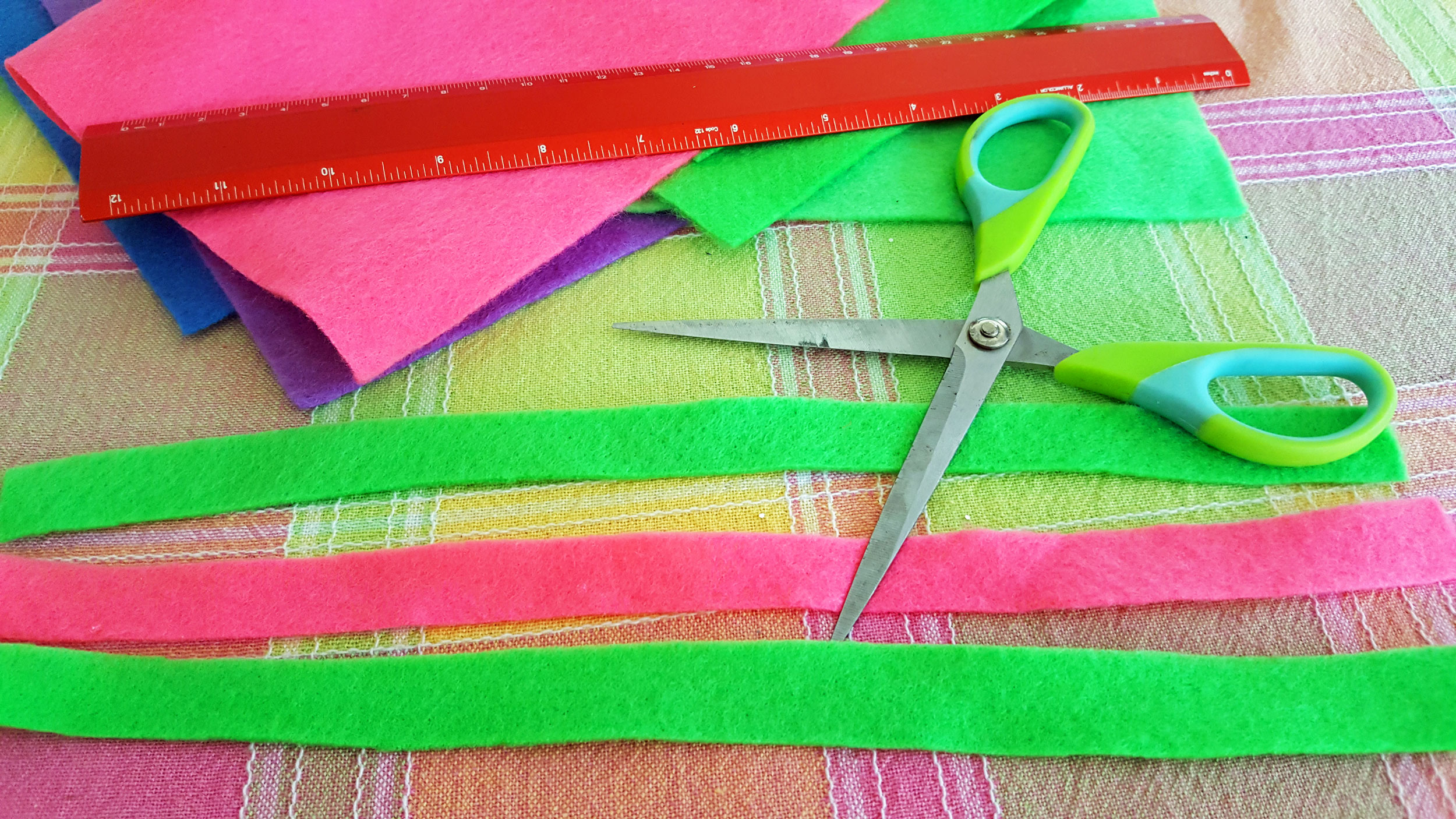 Step 1 is to cut three strips of felt - two strips of your primary color and one strip of your secondary color. | OrnamentShop.com