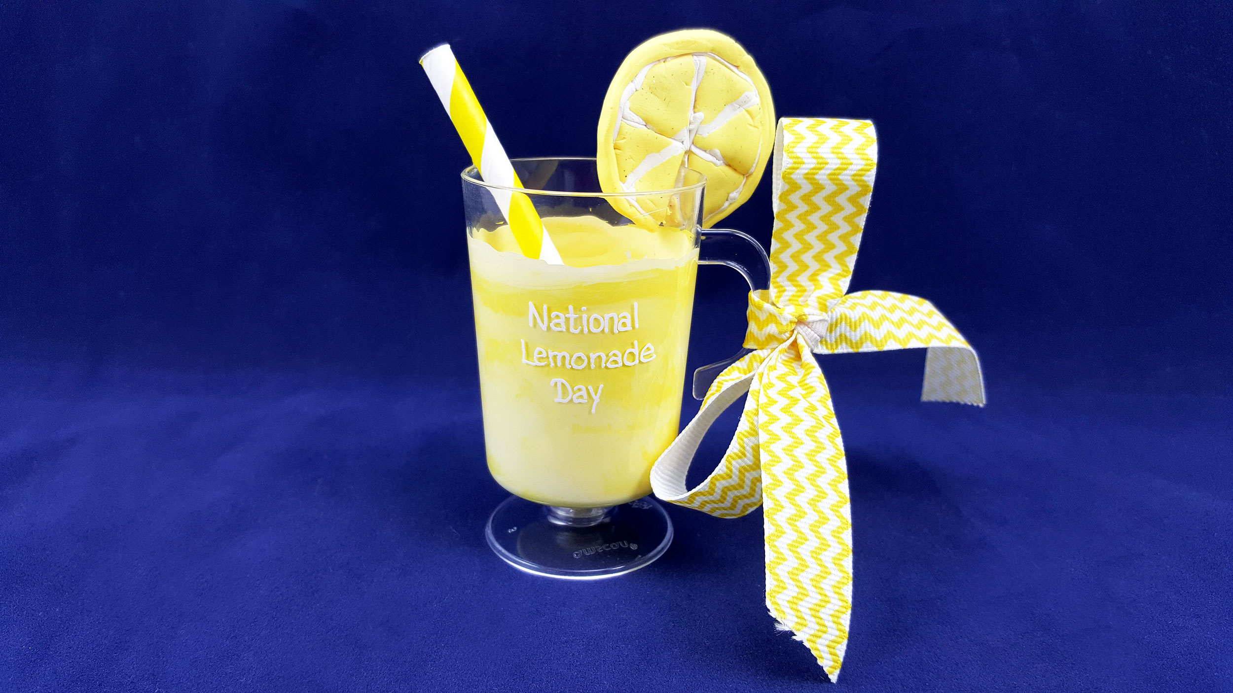 A DIY lemonade glass ornament with a clay lemon wedge on the brim. | OrnamentShop.com