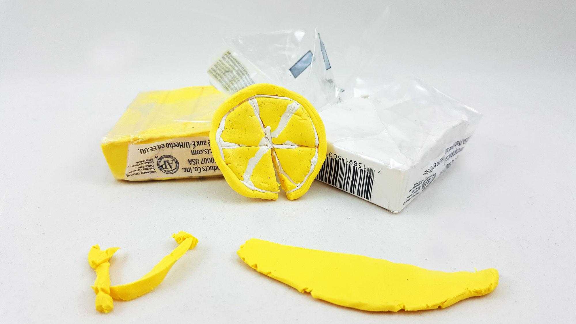 Step 2 is to use yellow and white clay to mold a piece of lemon. | OrnamentShop.com