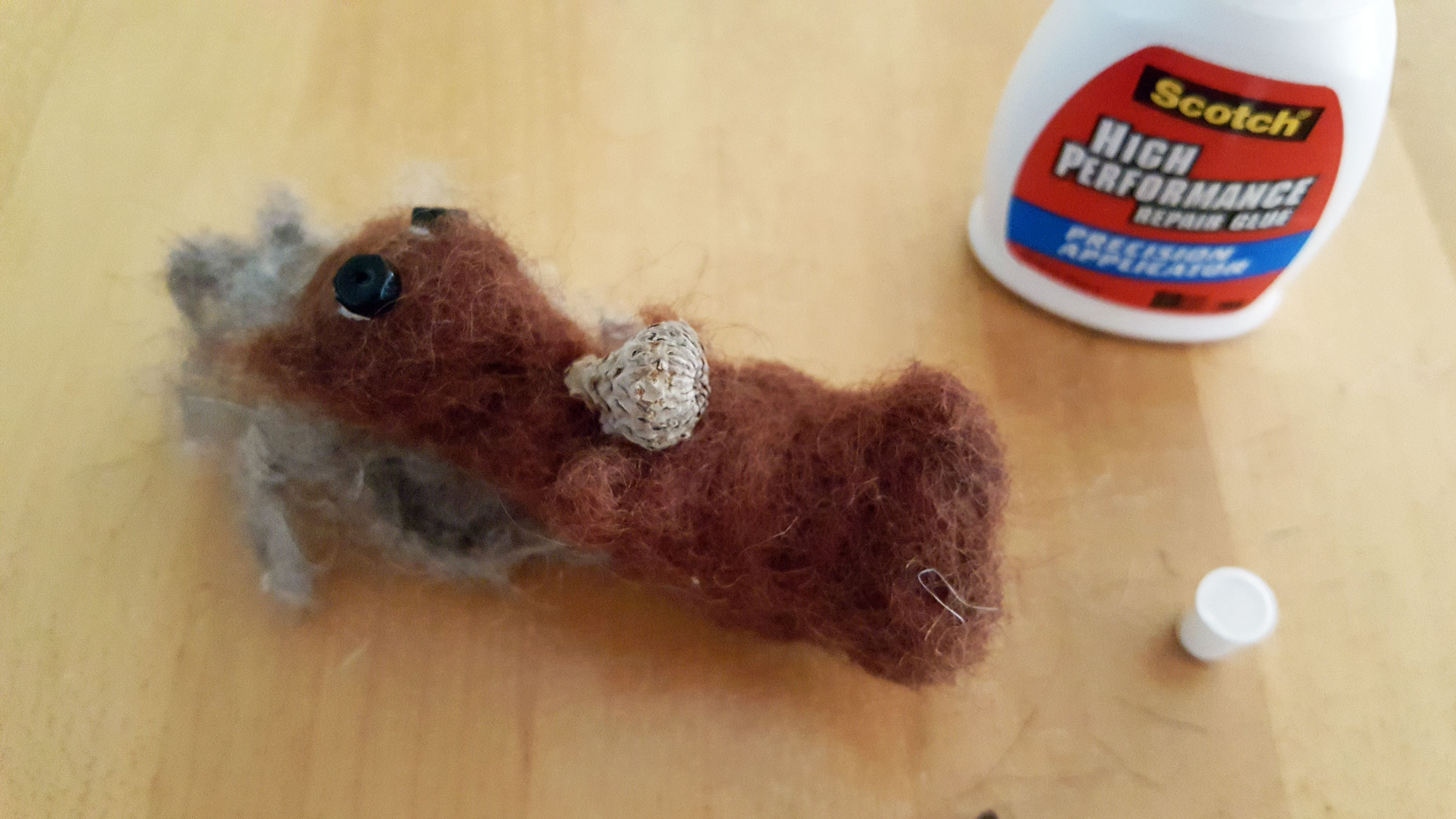 Step 8 is to glue a tiny acorn between the squirrel's hands. | OrnamentShop.com