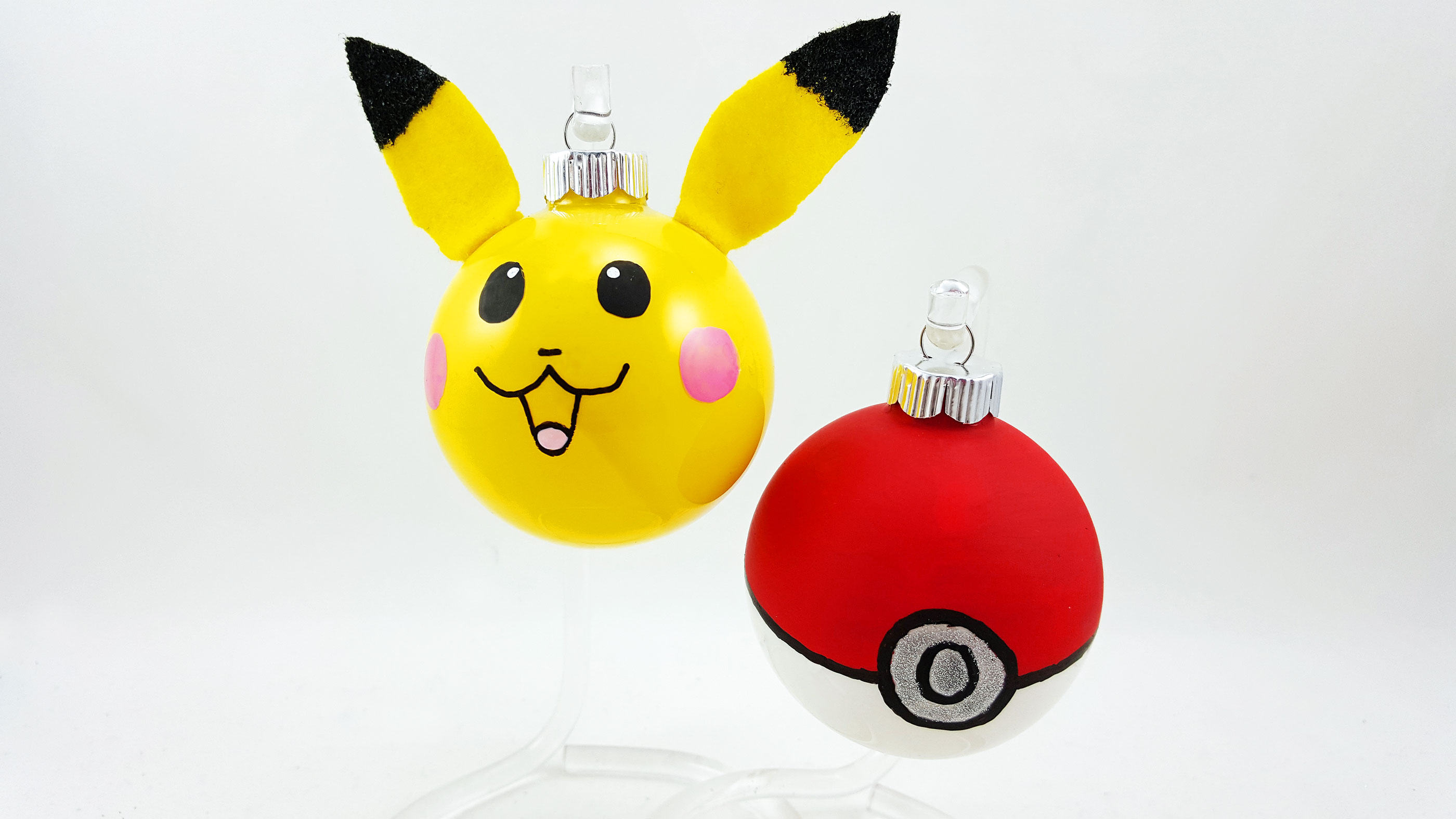 Two DIY Pokemon ornaments made from glass balls - a Pikachu and a Pokeball. | OrnamentShop.com