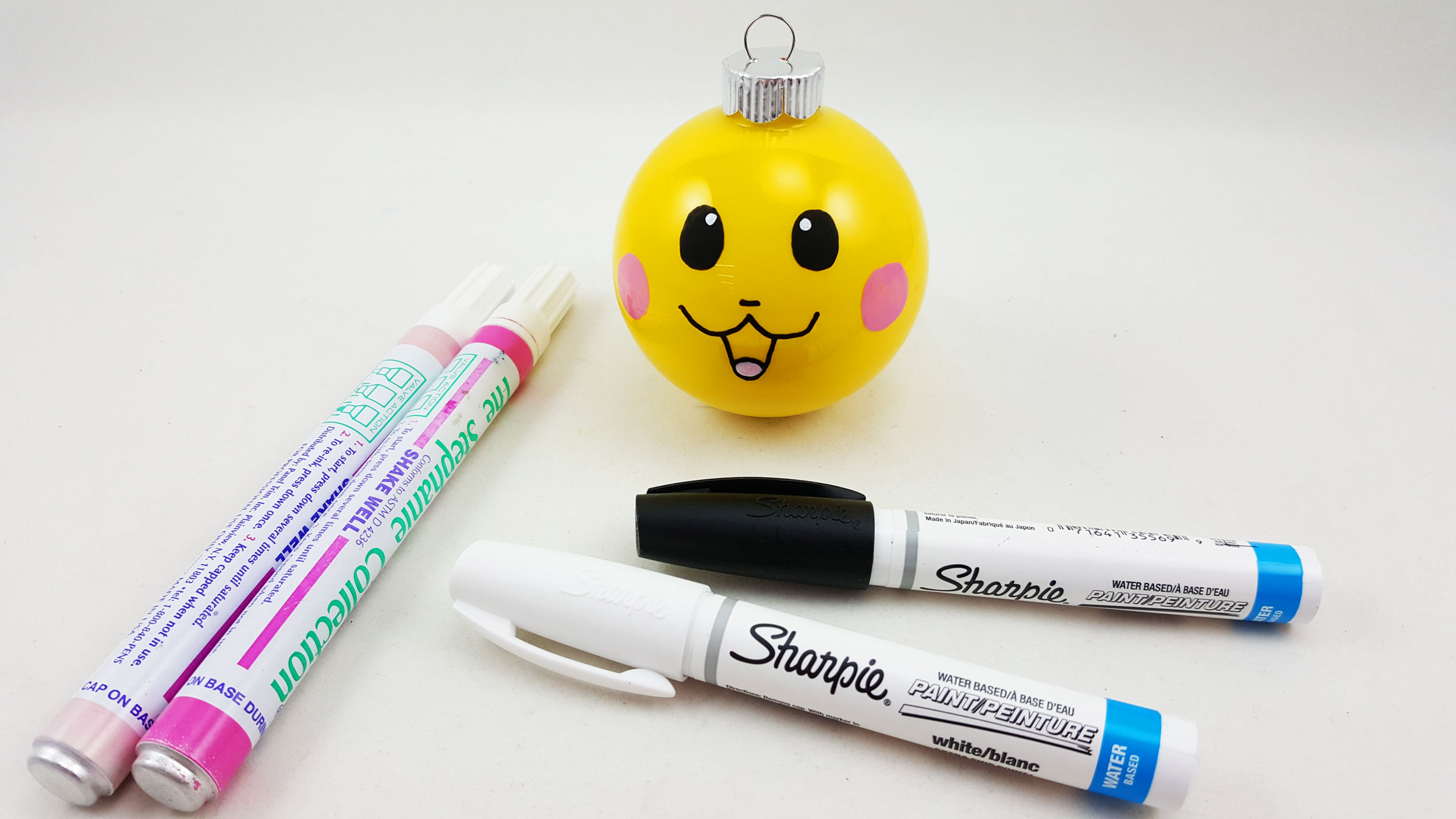 The third step to make a Pikachu ornament is to draw the face. Use how we drew the face as a guide, as the mouth is very important and uses a W shape with a U underneath. | OrnamentShop.com