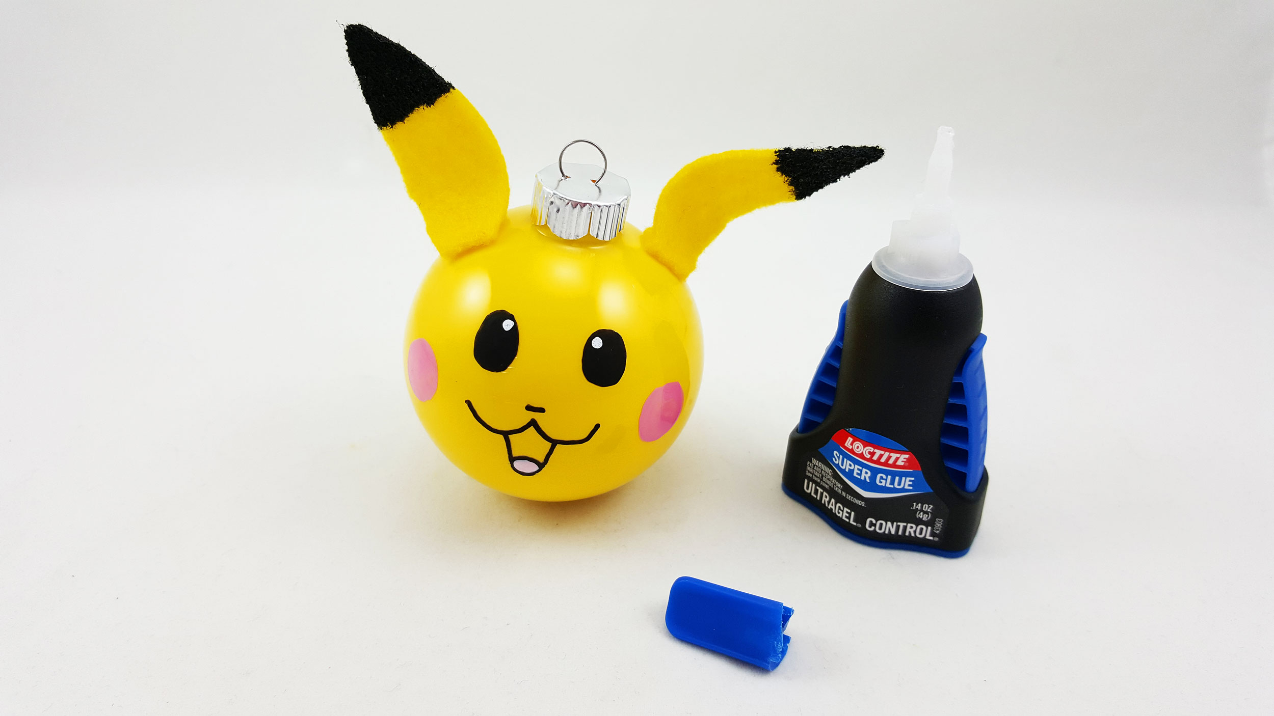 The final and fourth step to make a Pikachu ornament is to super glue the ears to the top of the ball. | OrnamentShop.com