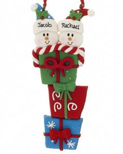 A table decoration with a stack of presents and snowmen on top. | OrnamentShop.com