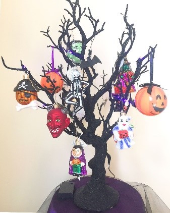 A black Halloween tree with various scary ornaments hanging. | OrnamentShop.com 