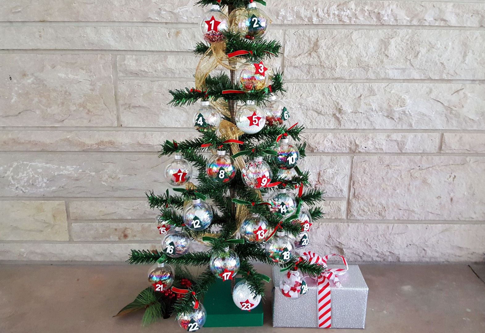 A Christmas Tree with Advent ornaments that count down until Christmas with unique Christmas-themed objects inside each one. | OrnamentShop.com