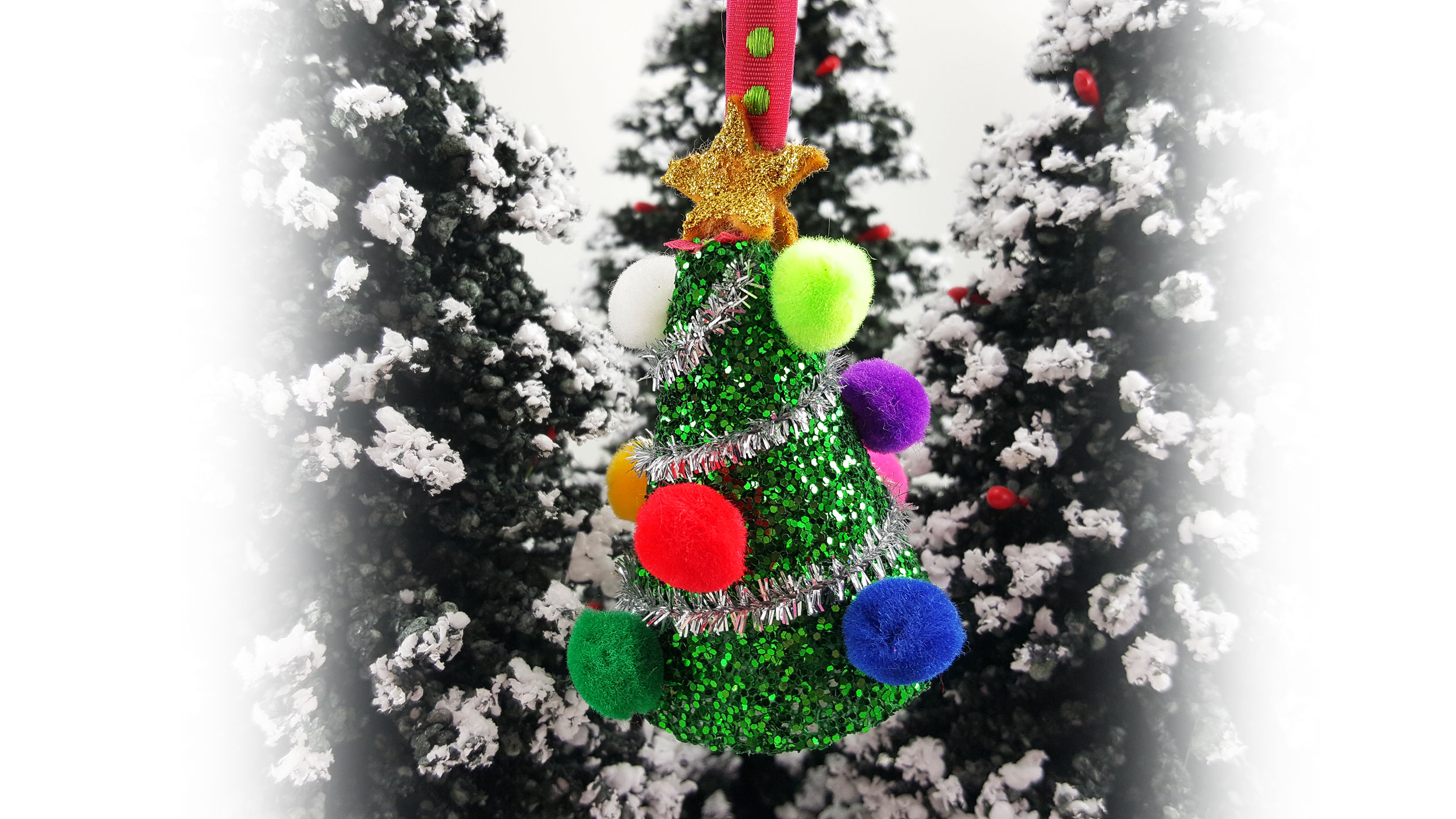 A Christmas crafts For kids. A DIY miniature Christmas tree with glitter and pom poms to hang as an ornament. | OrnamentShop.com