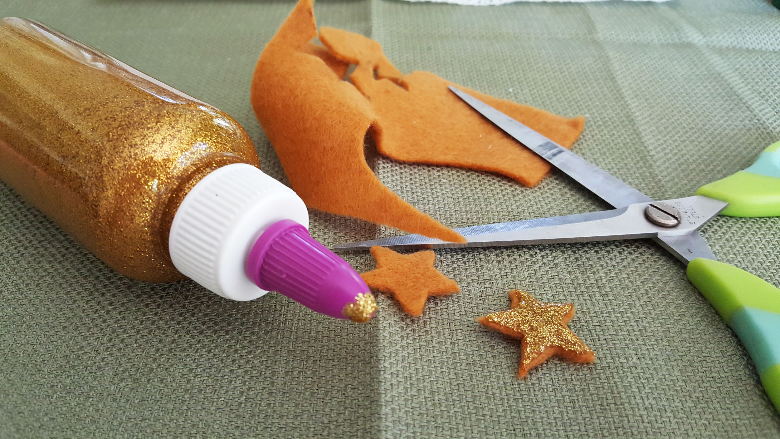 Step 2 for the Christmas Craft For Kids is to cut out two star felts and use glitter glue for one site. | OrnamentShop.com