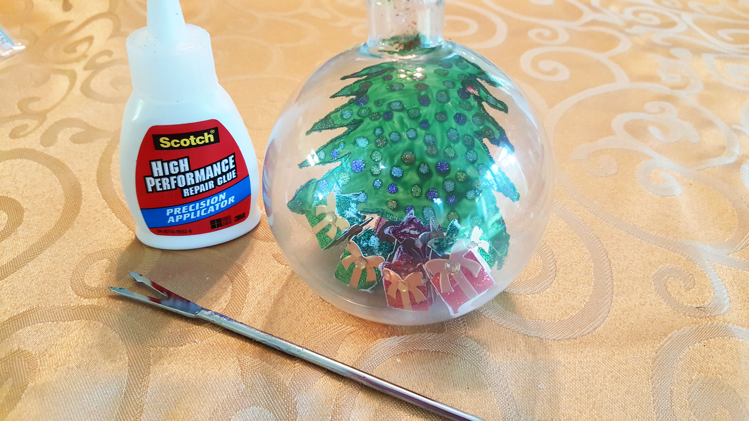Step 5 is to use just a tiny bit of blue on the bottom of your presents while putting them in place with tweezers. | OrnamentShop.com