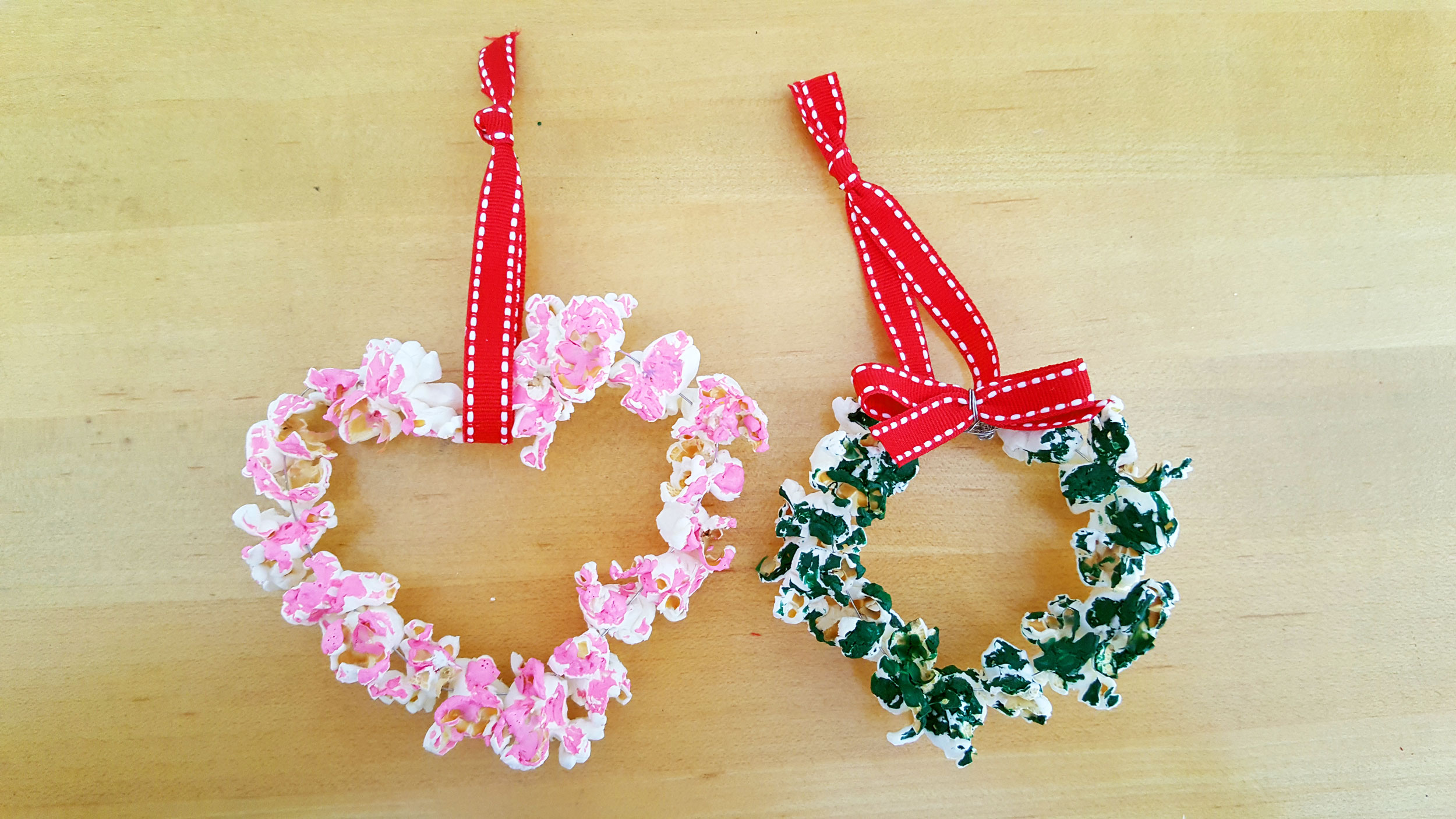 Two DIY popcorn ornaments, one shaped as a heart and the other a wreath. | OrnamentShop.com