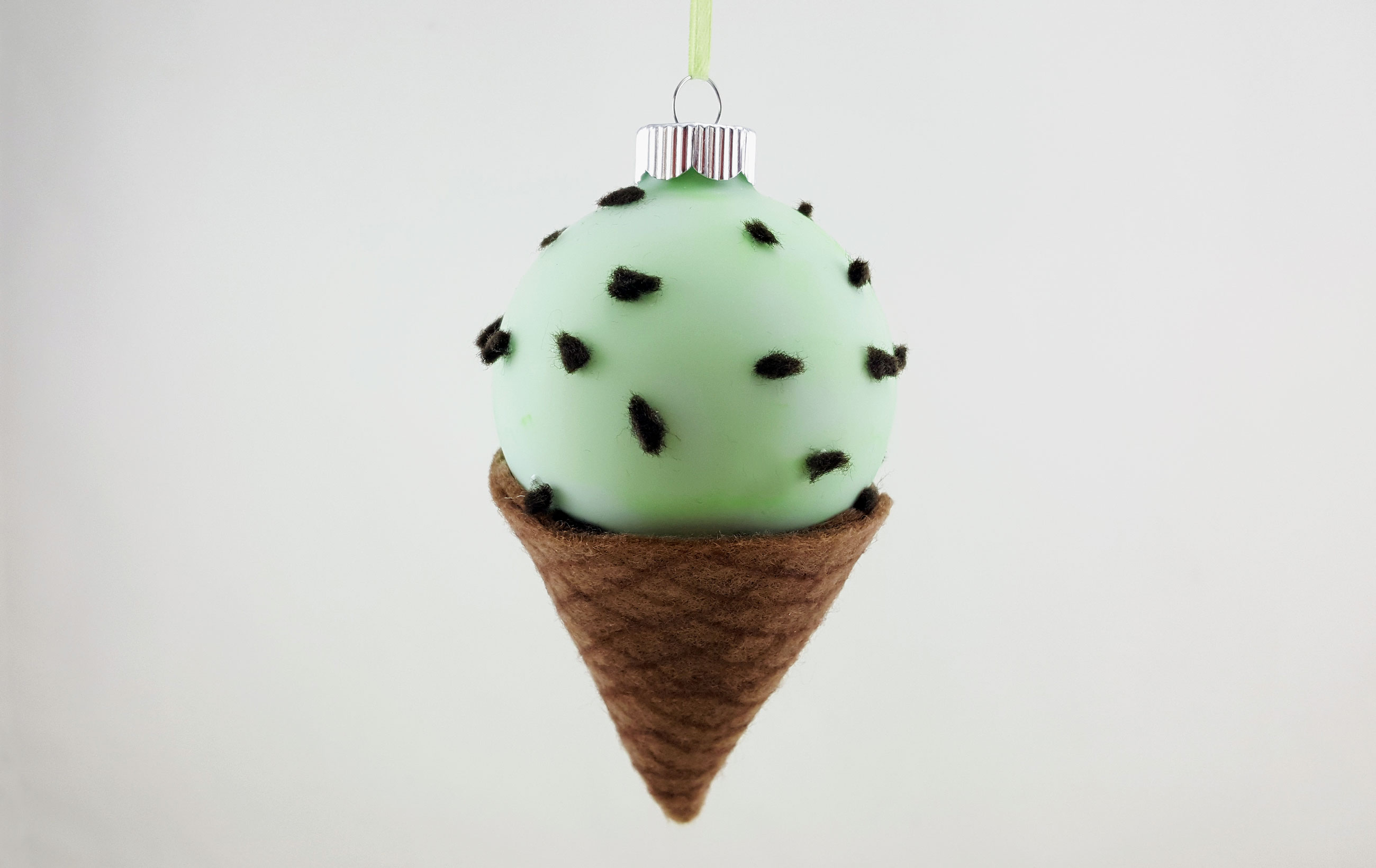A Chocolate Mint Ice Cream Cone ornament decoration hangs from its own ornament stand for display by your desserts. | OrnamentShop.com