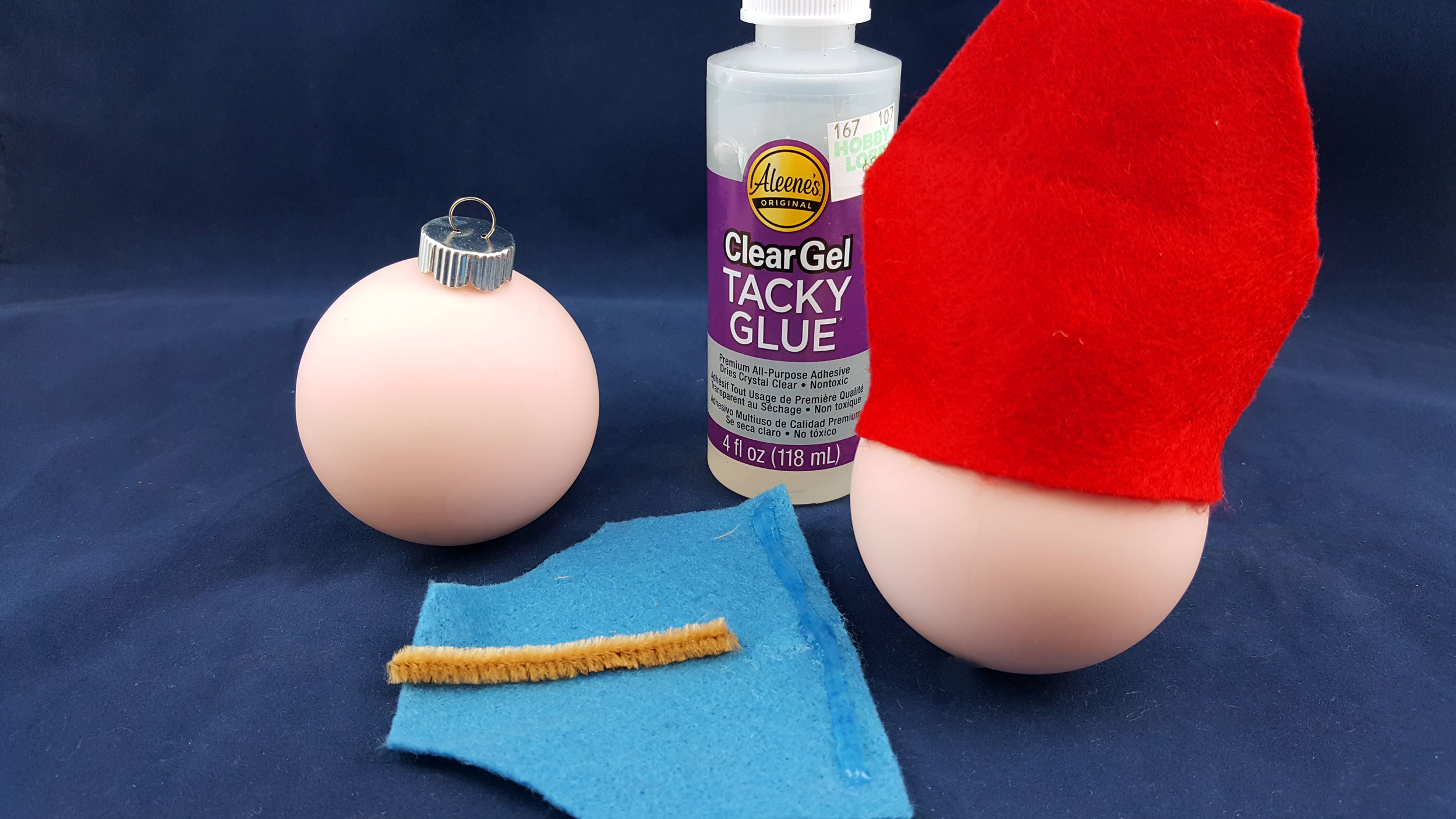 Run a line of glue along the bottom of the piece of felt and secure to the glass ball ornament. | OrnamentShop.com