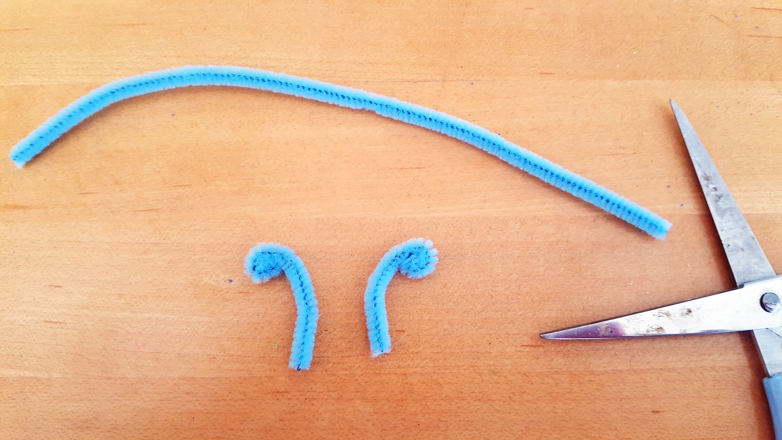 Step 8: Now, cut the pipe cleaners into the antennae, curling the ends. | OrnamentShop.com
