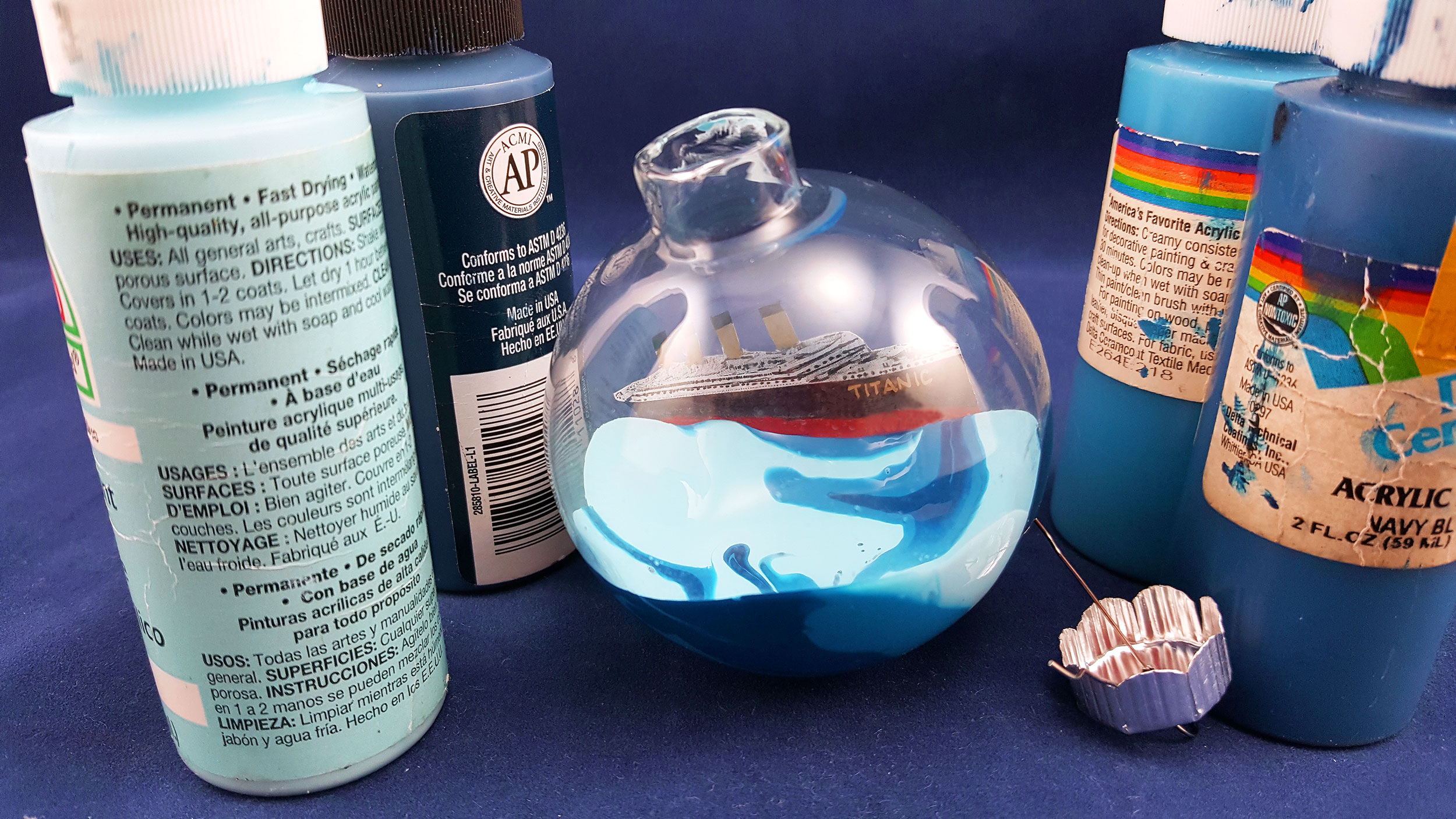 For Step 3, mix the blue paints together and fill the glass ball ornament. | OrnamentShop.com