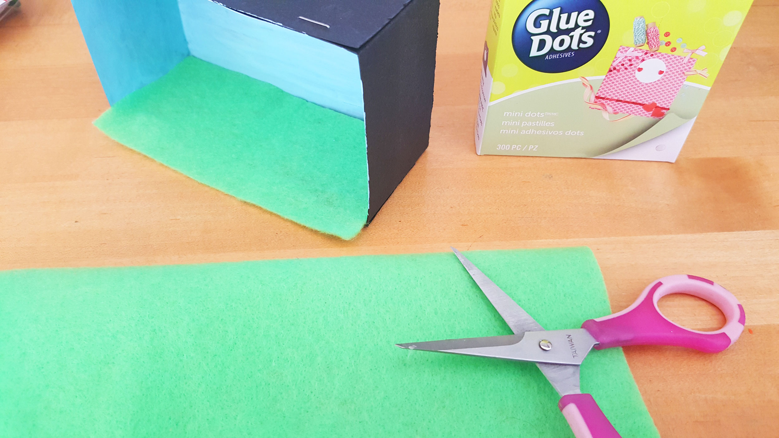 Step 3: While the paint is still drying, cut a piece of the green felt in a size that will cover the bottom of your DIY shadow box. | OrnamentShop.com