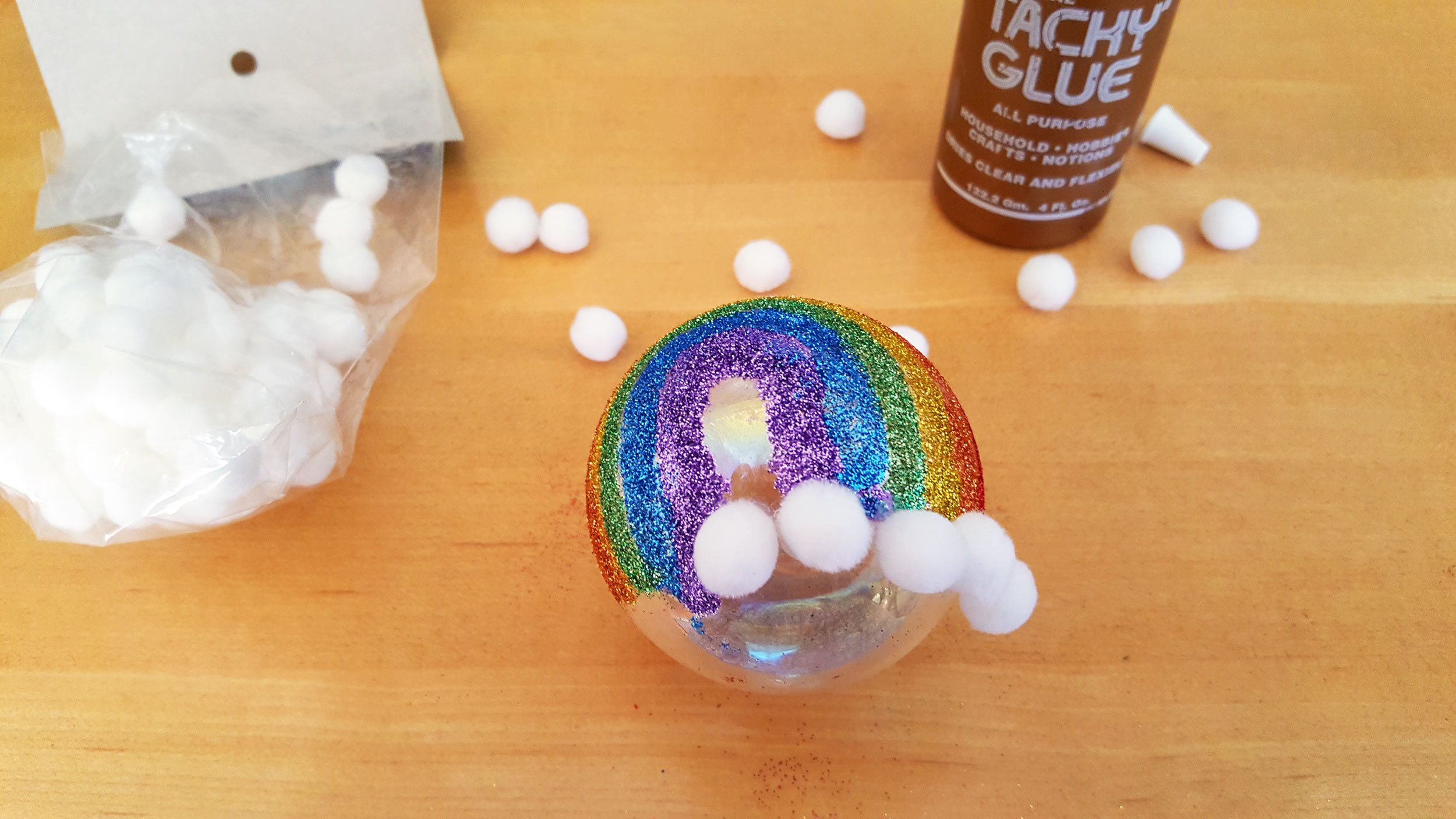 Step 3: Using the glue, carefully add the individual pompoms to the bottom of your rainbow and out to the sides. | OrnamentShop.com