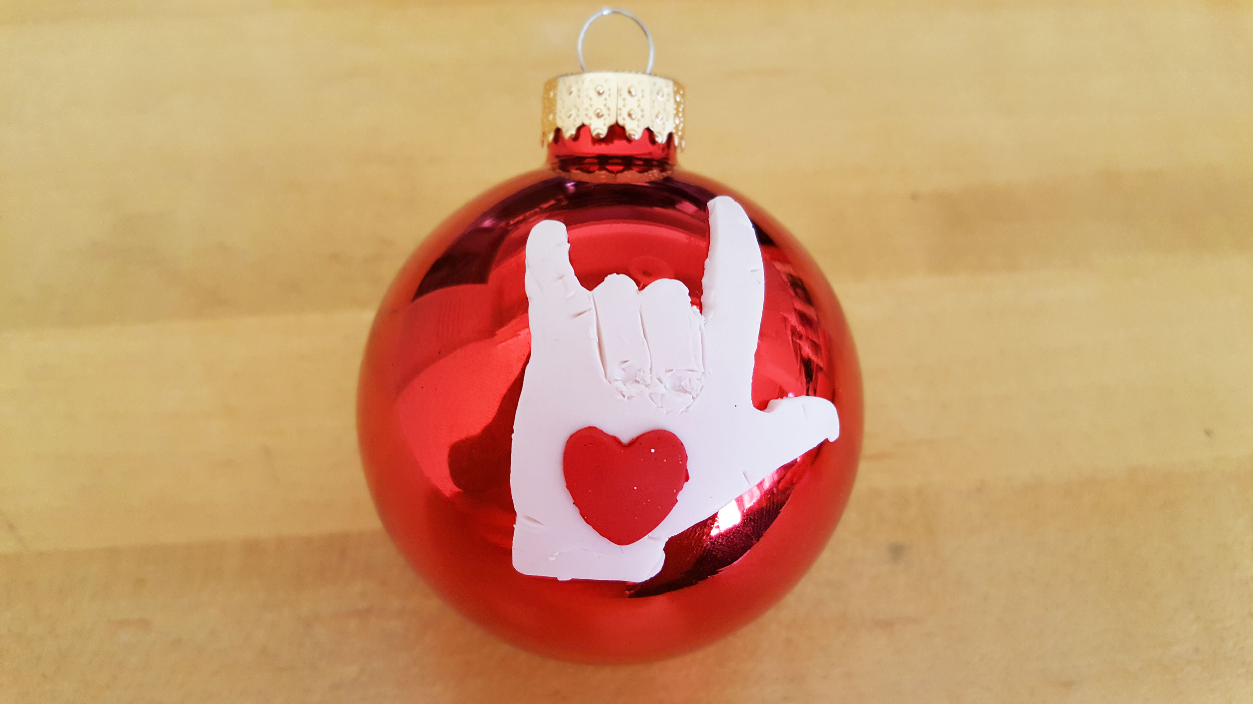 "Rock out" hand with red heart on red glass ball ornament | OrnamentShop.com