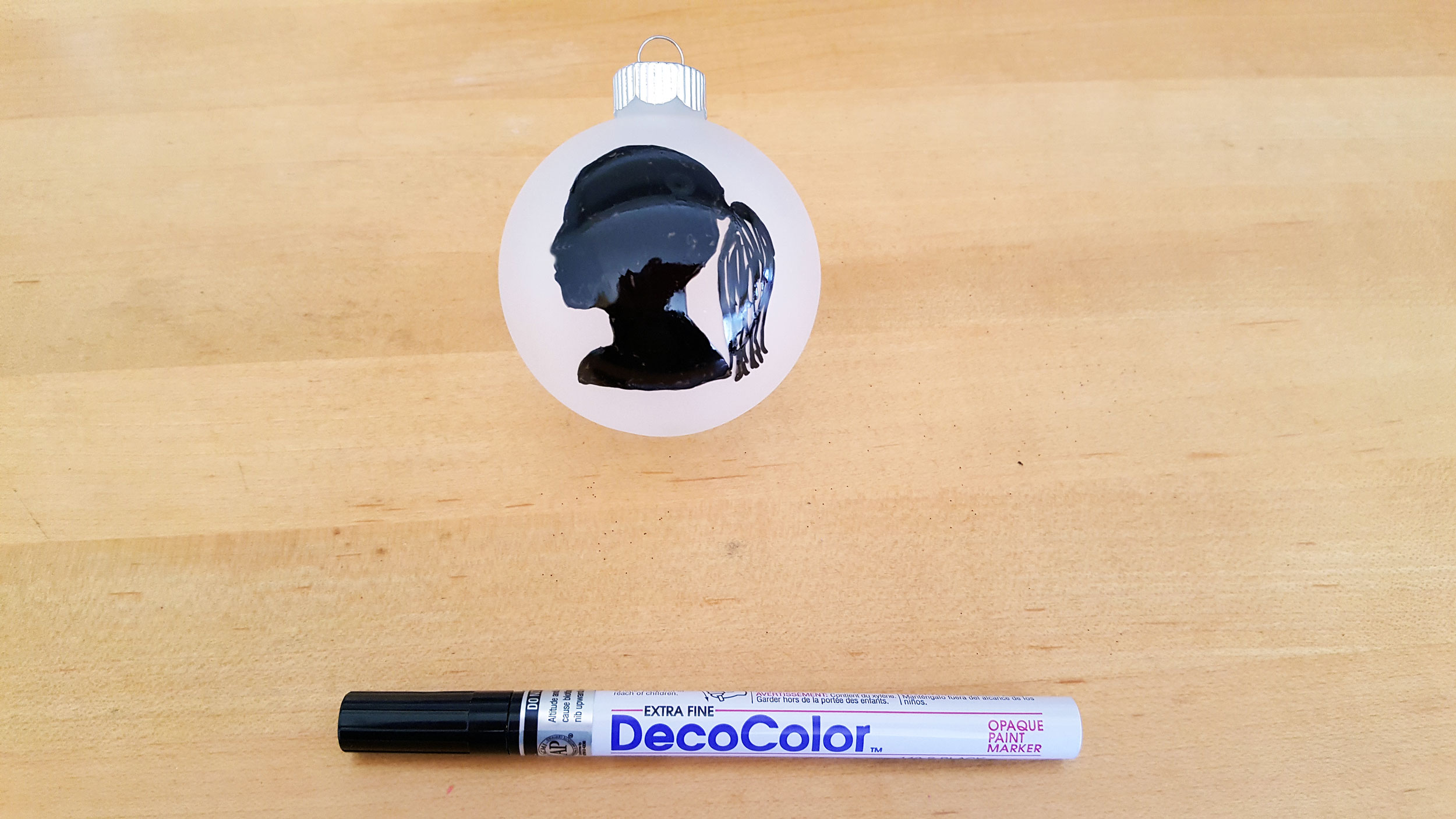 Frosted glass ball ornament with black marker outline filled in with DecoColor black marker. | OrnamentShop.com