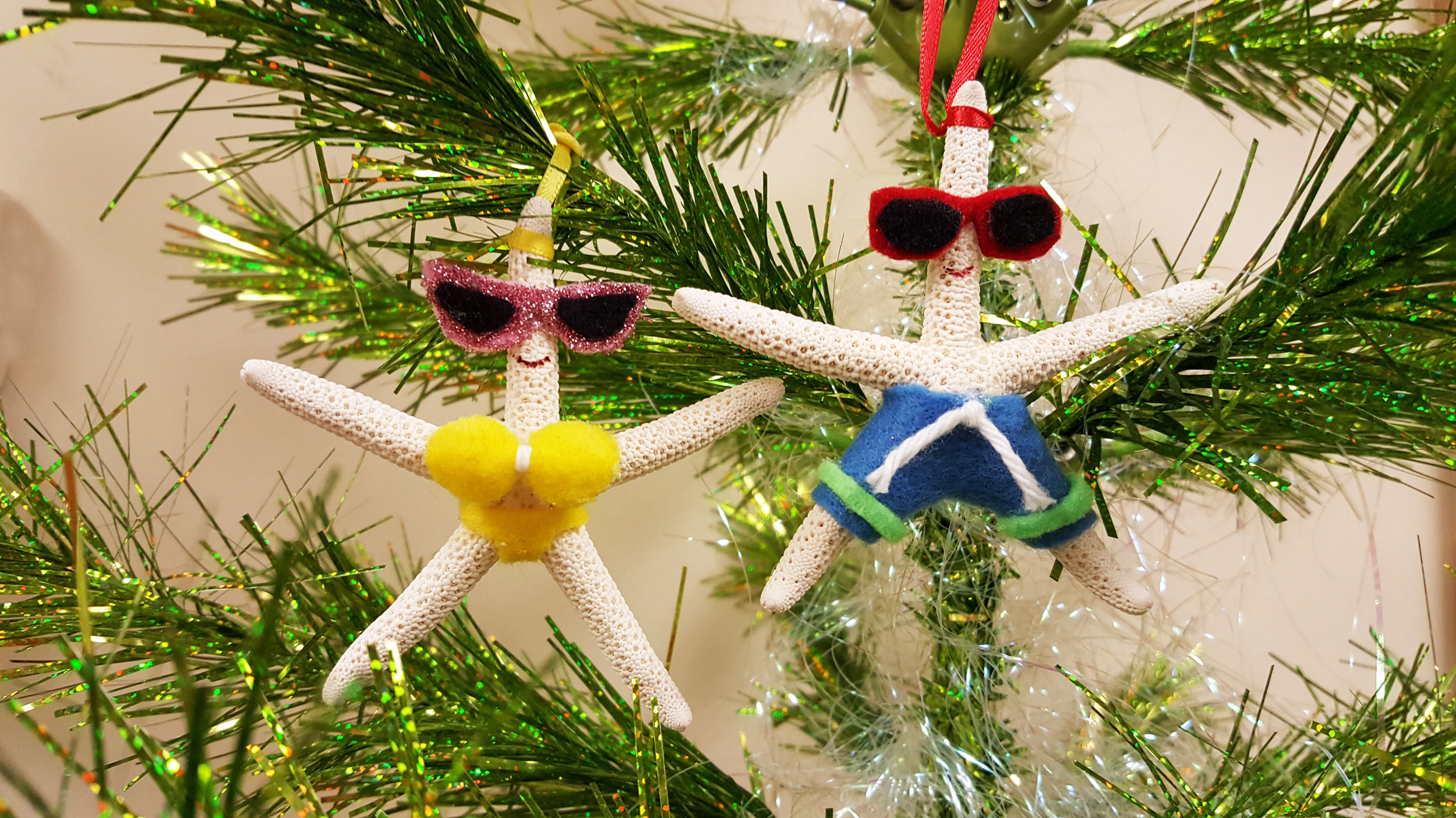 Completed starfish ornaments hanging on green Christmas tree | OrnamentShop.com