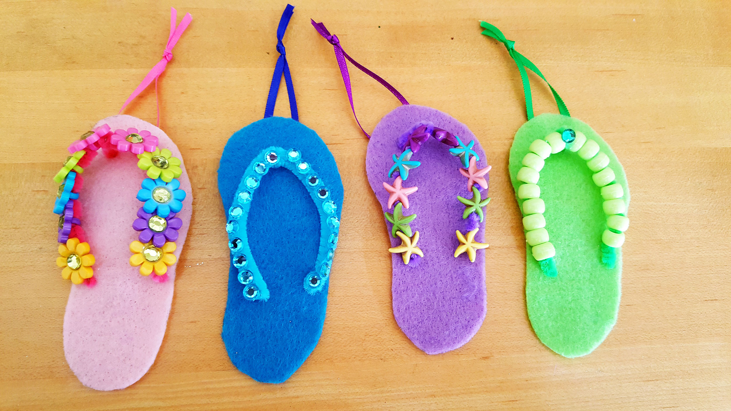4 completed felt flip flops with pony beads and colorful ribbons. | OrnamentShop.com