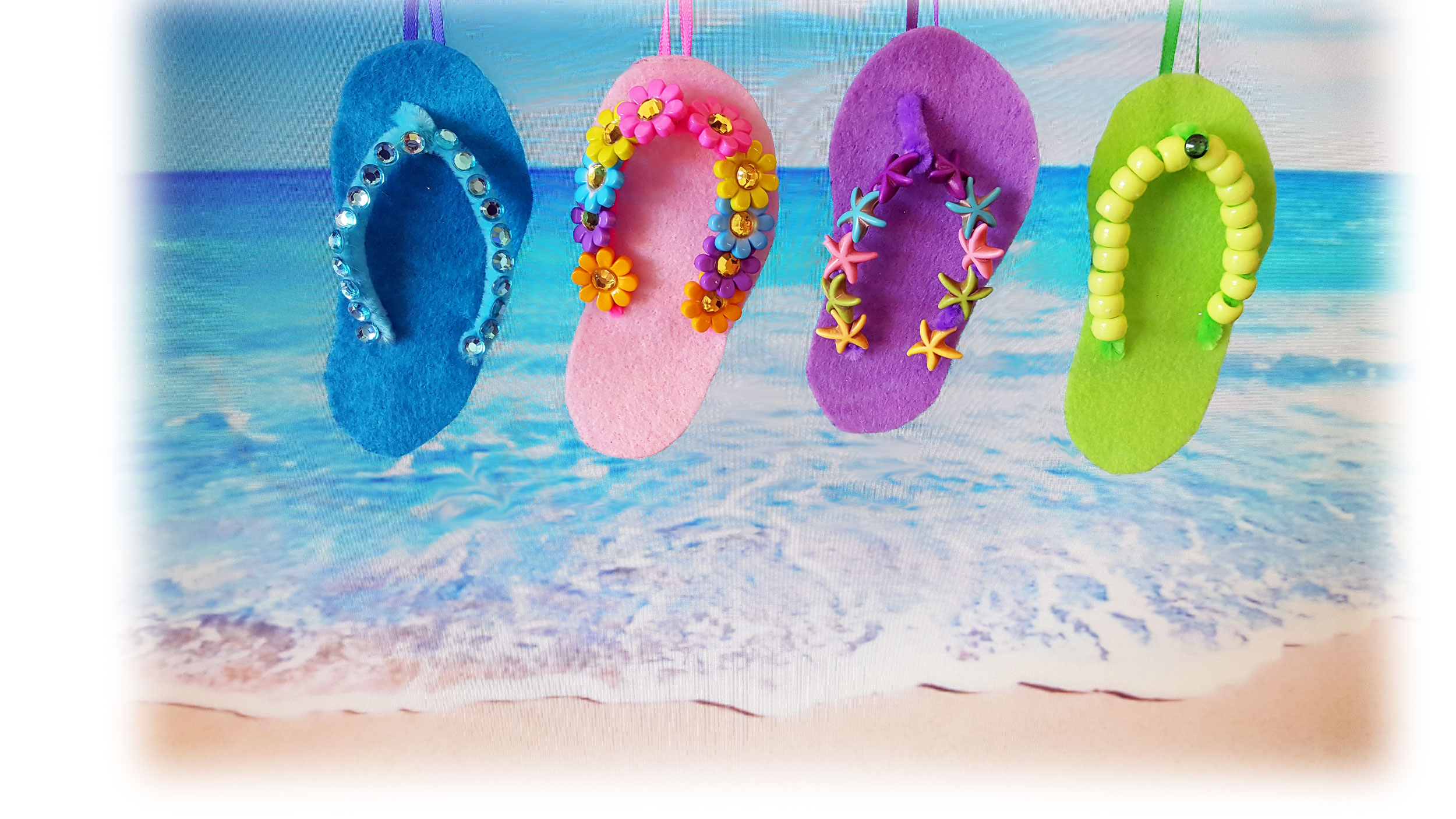 4 colorful and decorative finished DIY felt flip flops in a row with beach background. | OrnamentShop.com