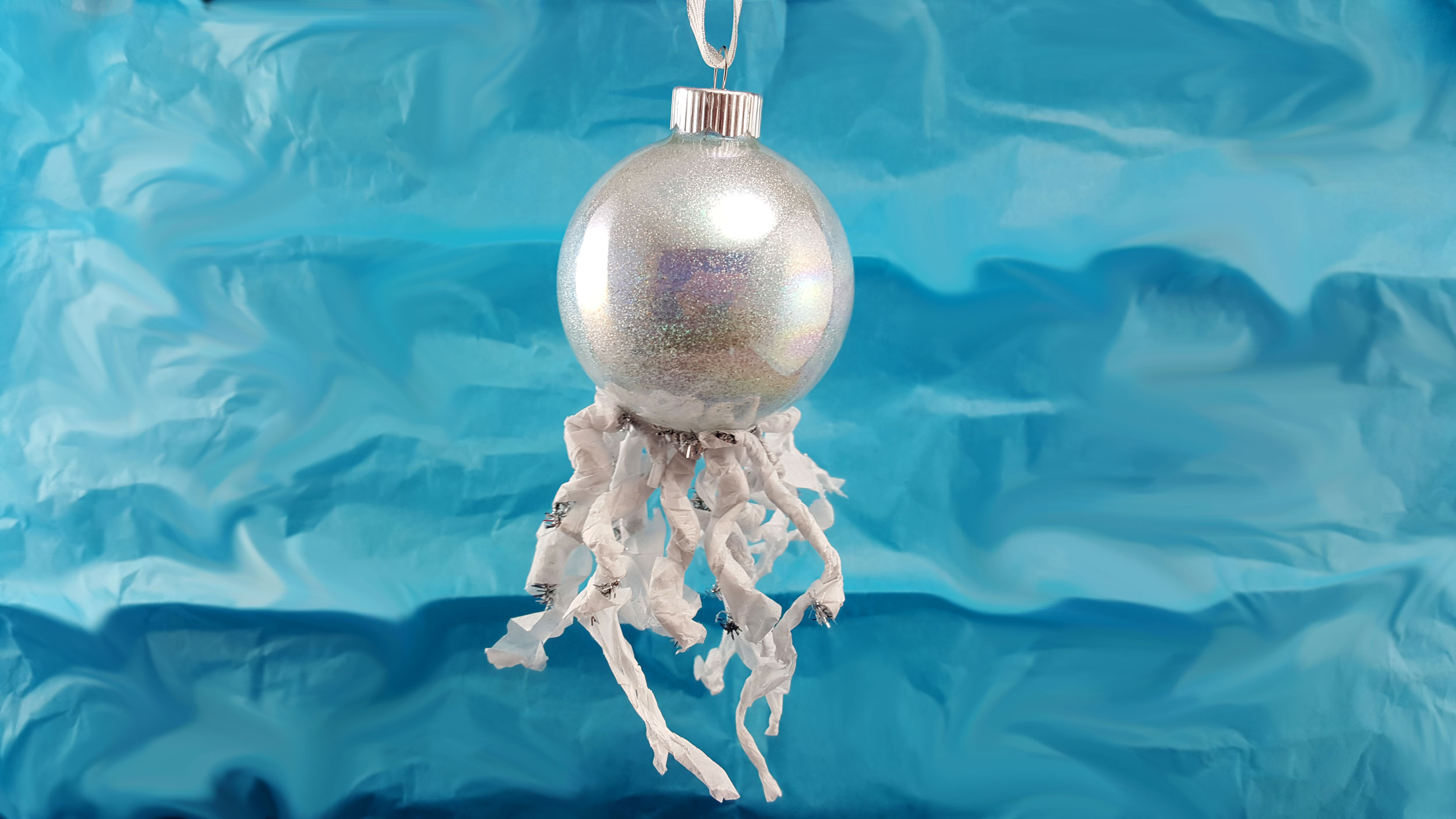 Completed iridescent jellyfish ornament with blue backdrop. | OrnamentShop.com