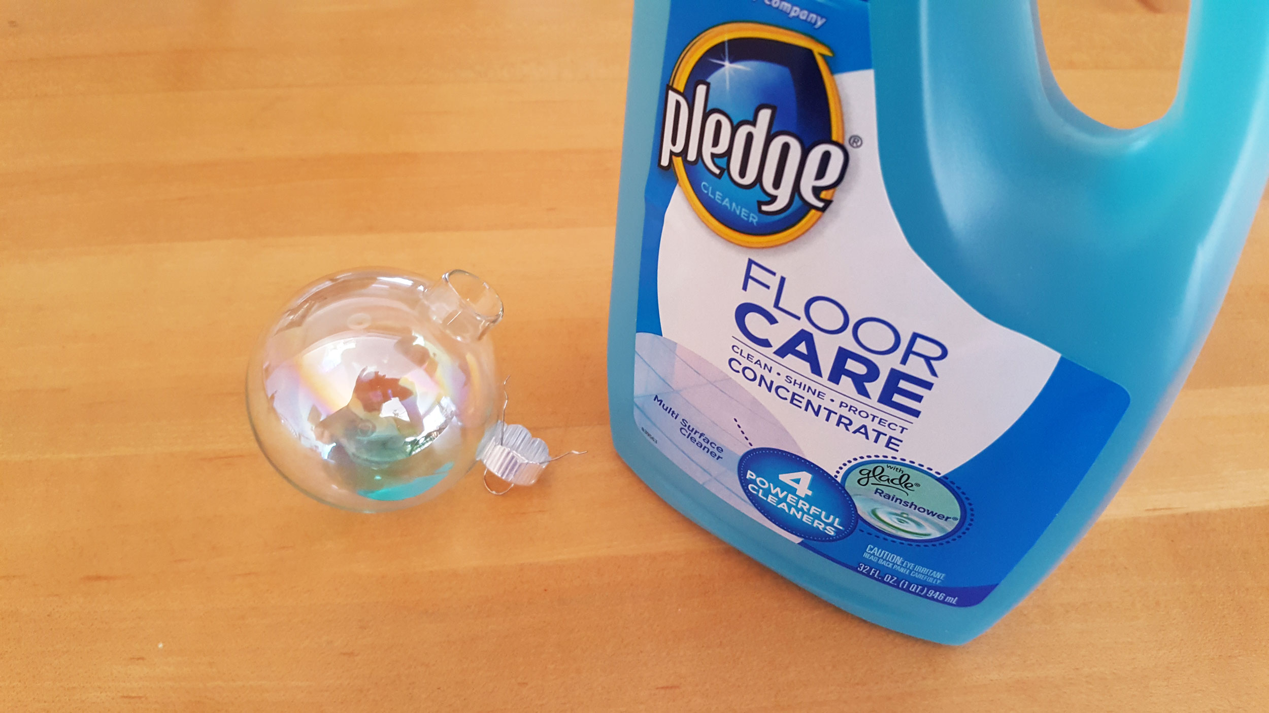 Pledge floor care poured into clear glass ball ornament. | OrnamentShop.com