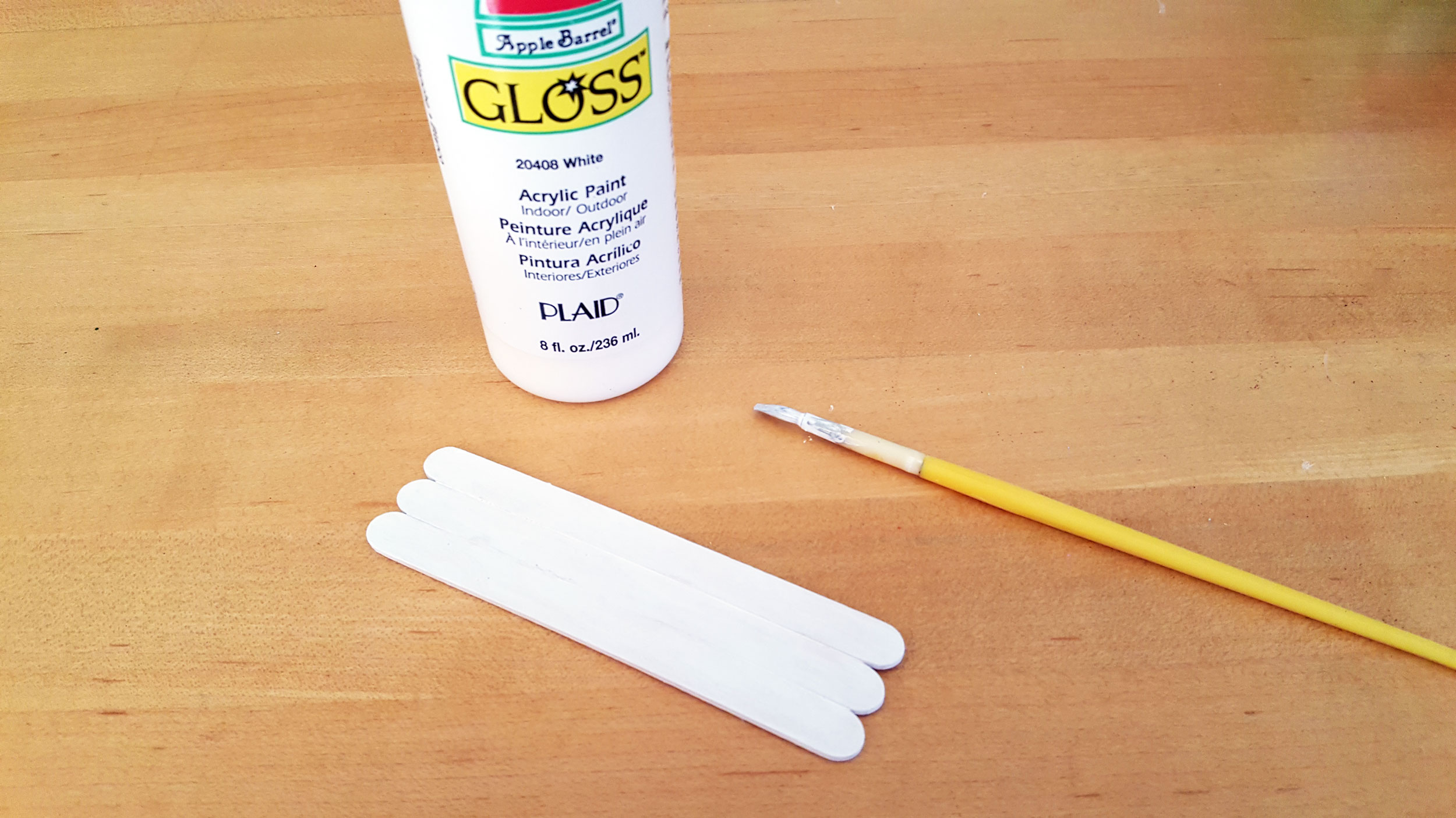 Step 2 is to paint the front of the popsicle sticks white for marshmallow. | OrnamentShop.com