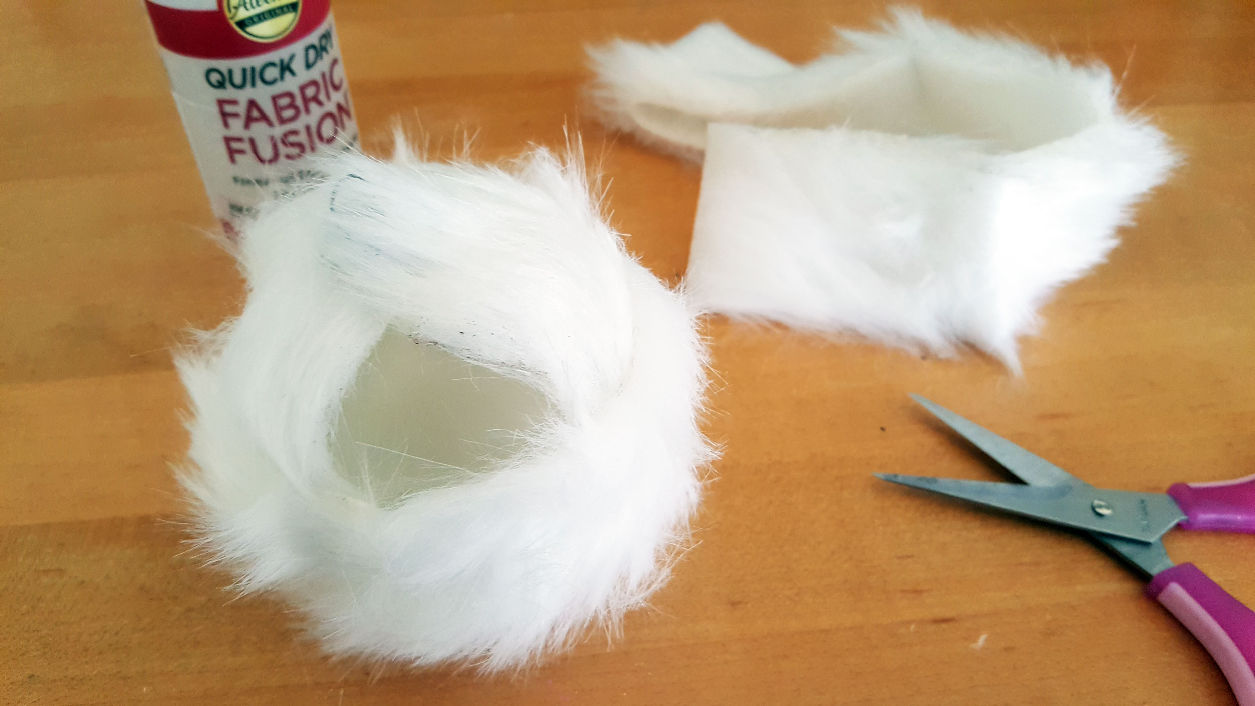 Smallfoot DIY Step 2 is to cut and glue another faux fur strip latitude on the ornament to cover the whole ornament in fur. | OrnamentShop.com