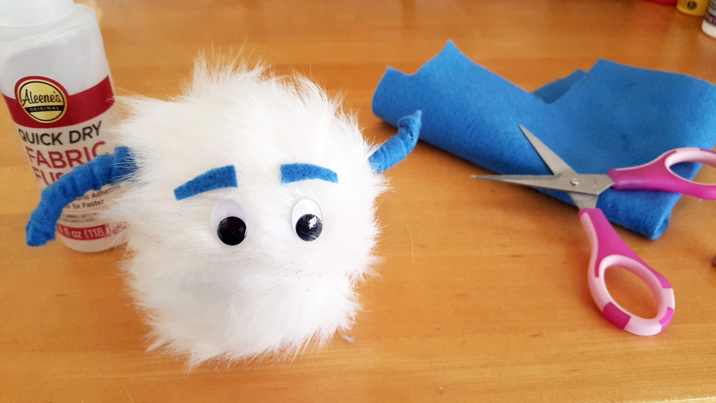 Smallfoot DIY Step 8 is to cut the eyebrows with blue felt and place above the eyes. | OrnamentShop.com
