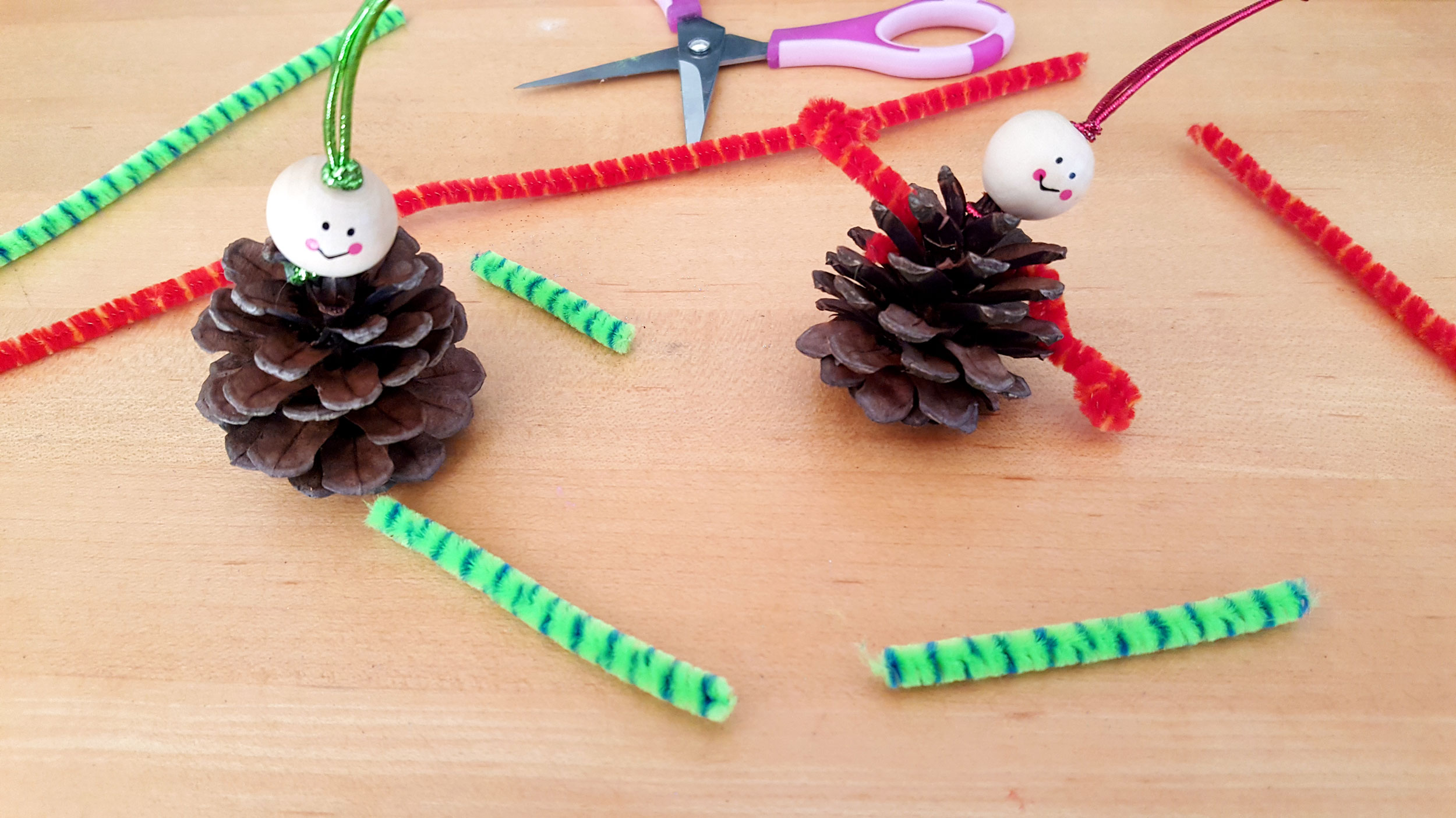 Pine Cone Elf Ornaments Step 3: Using scissors, cut two arms and two legs from the pipe cleaners. | OrnamentShop.com