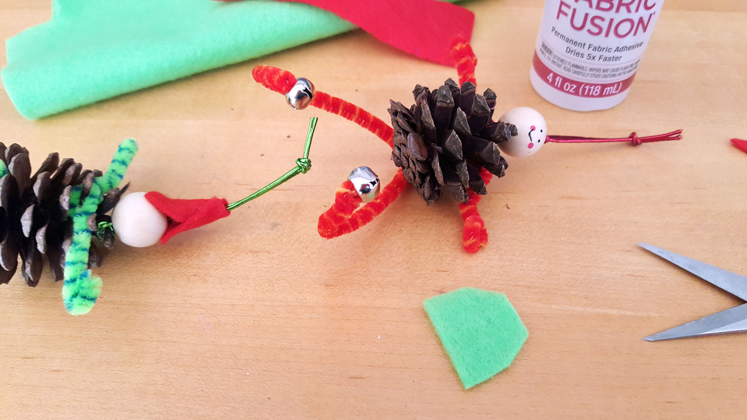 Pine Cone Elf Ornaments Step 5: Pine core ornaments with pipe cleaner legs. | OrnamentShop.com