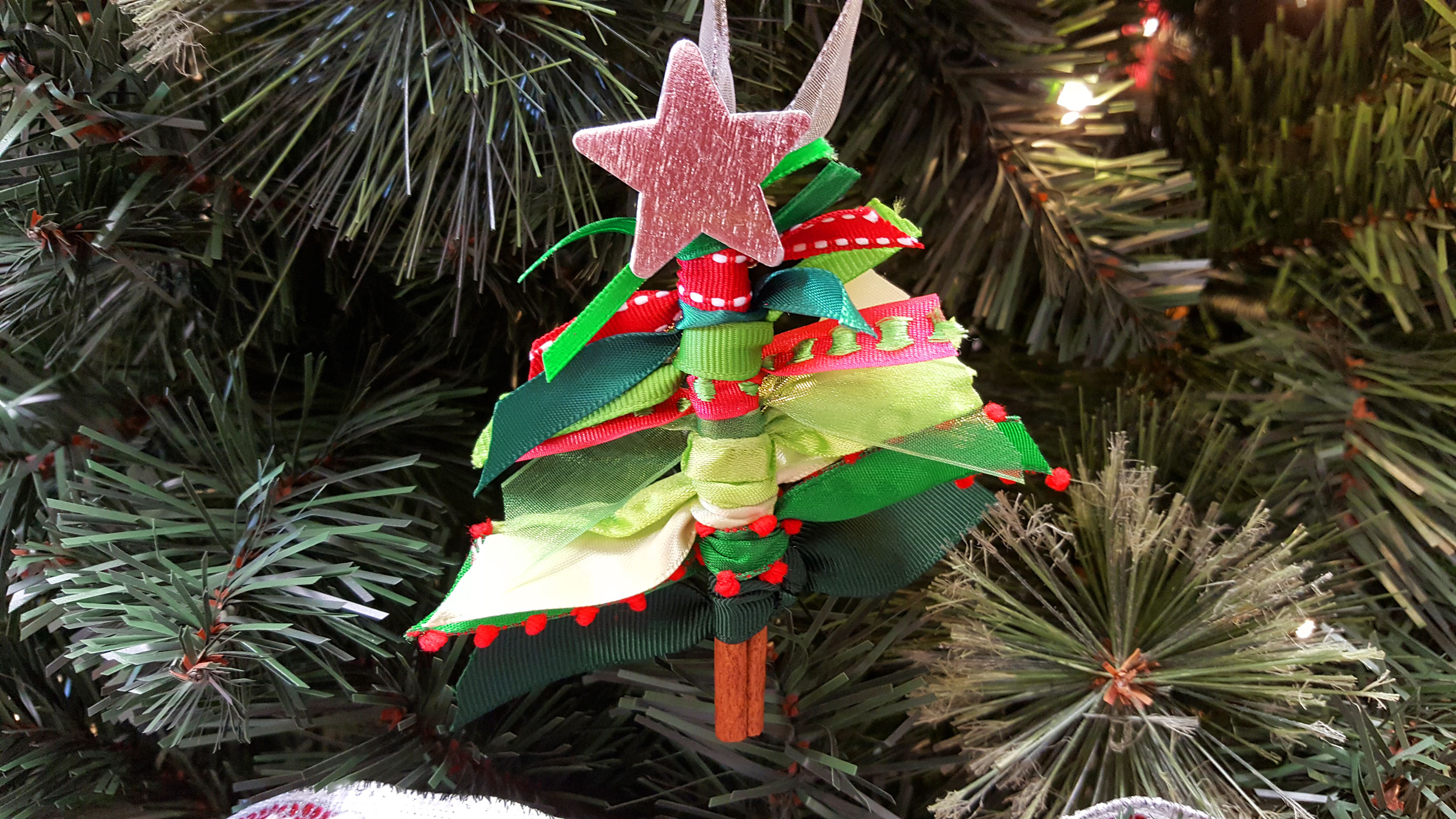 Completed Ribbon Tree Ornament hanging on a tree. | OrnamentShop.com