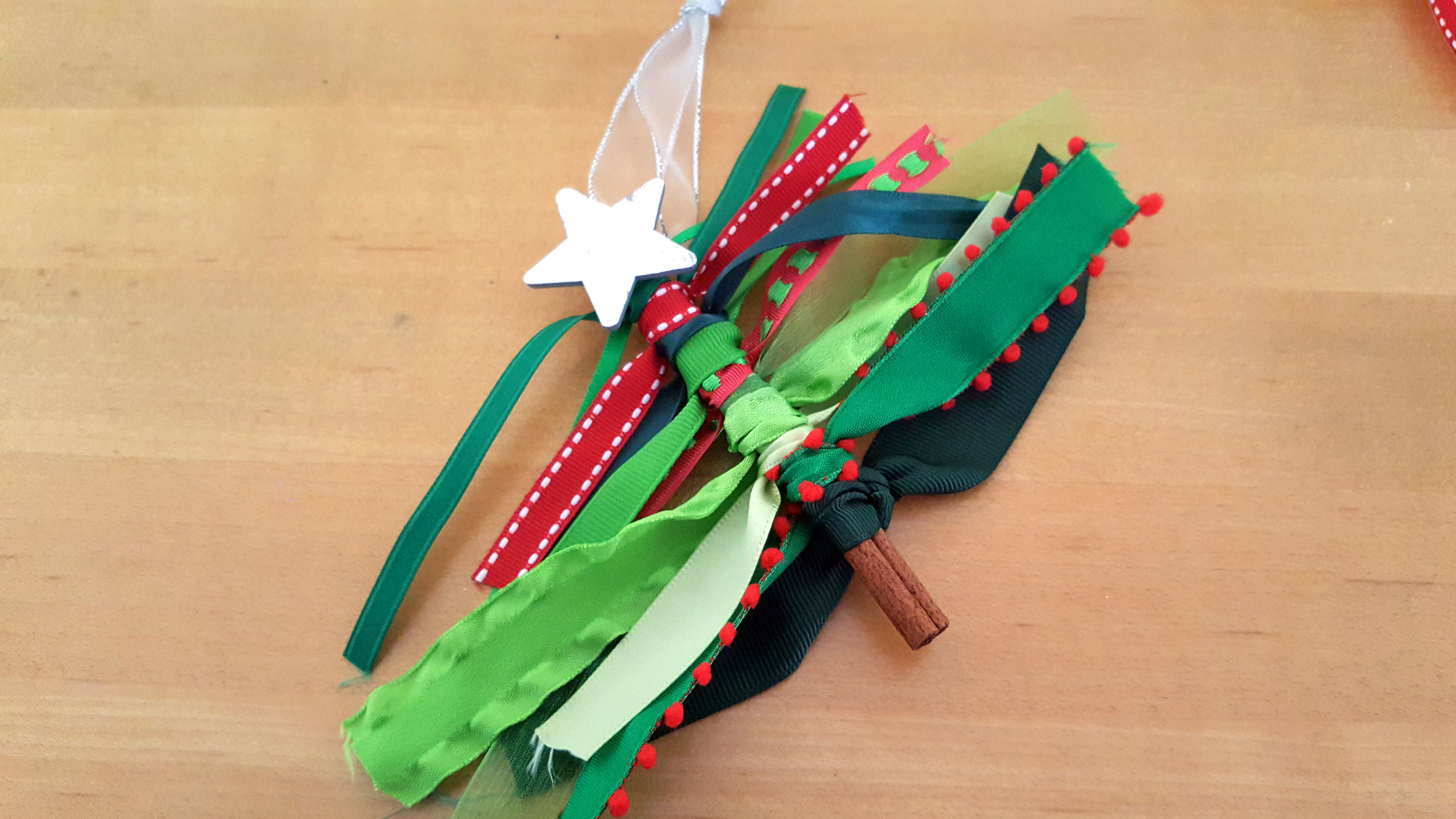 Ribbon tree ornament tie ribbons to the top star. | OrnamentShop.com