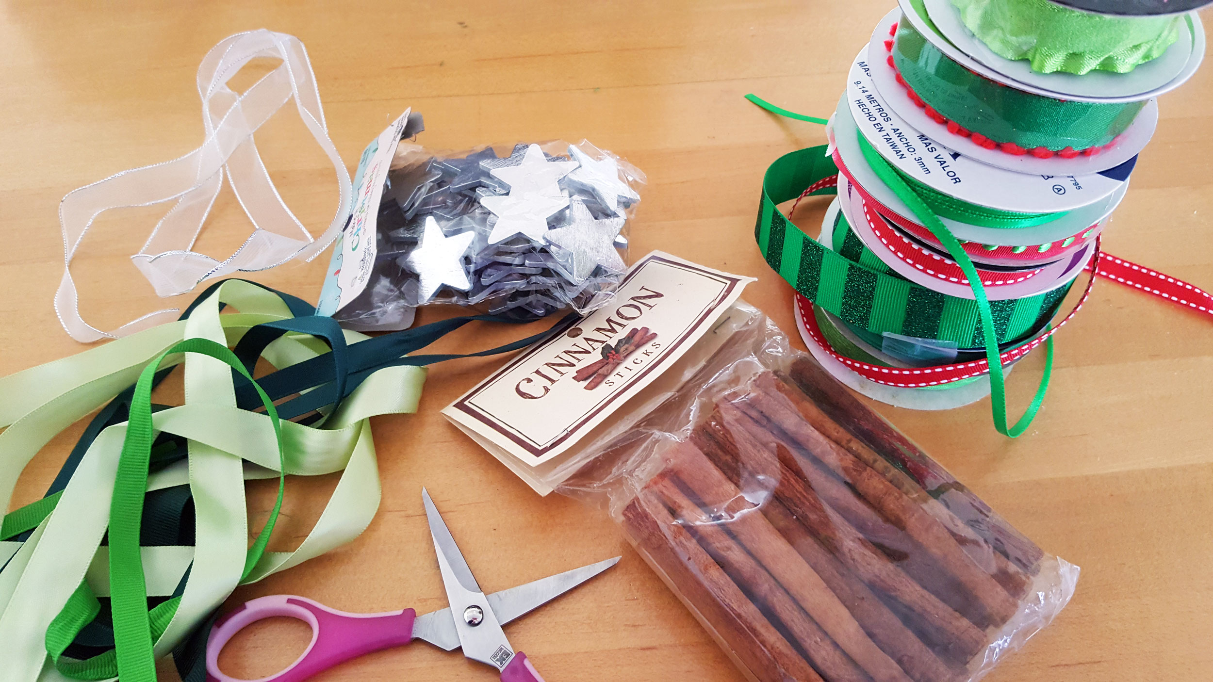 Ribbon tree ornament supplies, including cinnamon sticks, ribbon, scissors, glue. | OrnamentShop.com