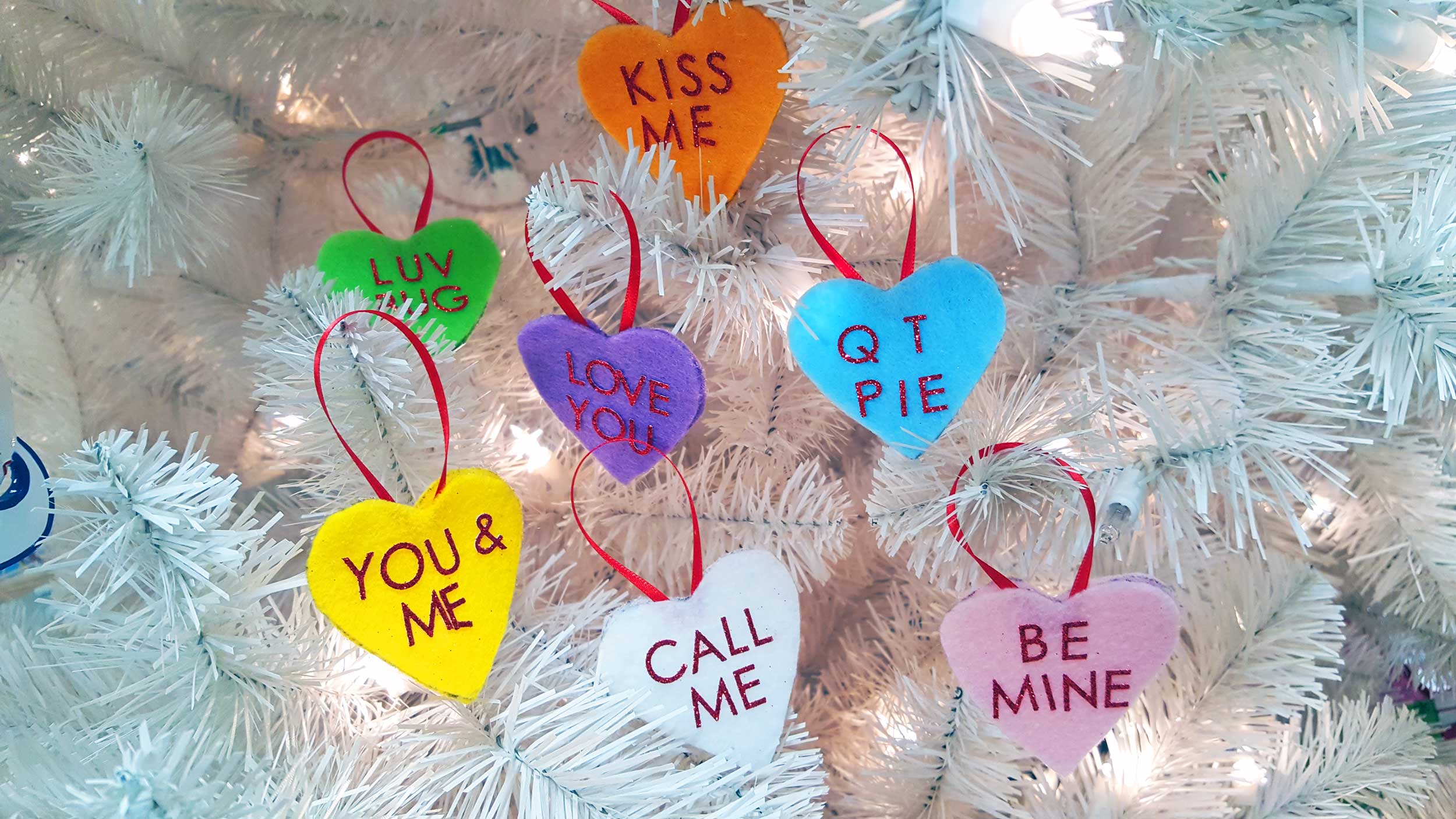 Valentine's Day ornaments on a white tree with Conversation Hearts. Adorable DIY gifts! | OrnamentShop.com