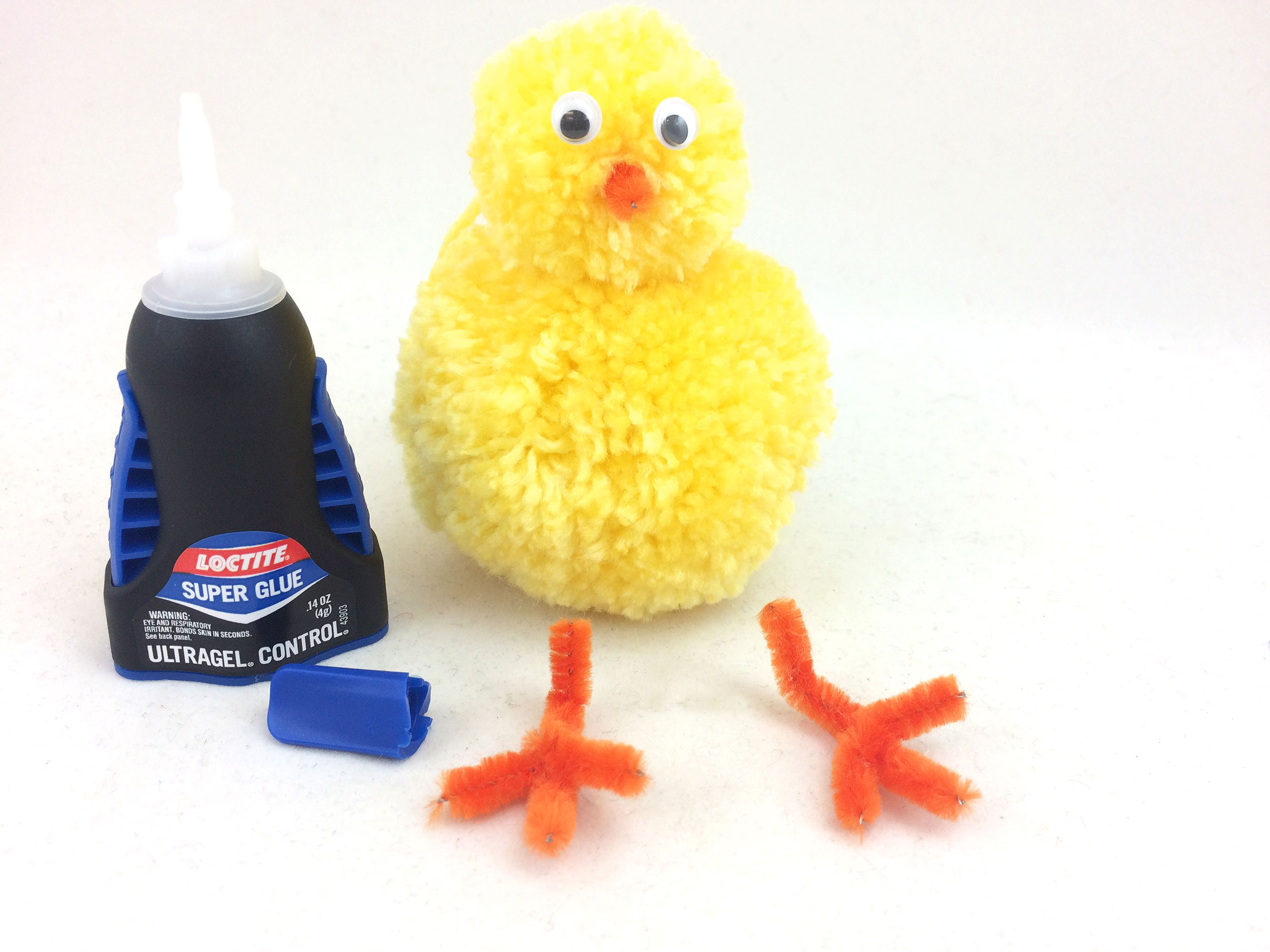 Glue googly eyes and beak to DIY Easter Chick head and pipe cleaner feet to body. | OrnamentShop.com