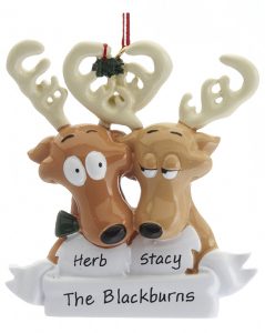 an ornament with two reindeer under a mistletoe about to kiss. | OrnamentShop.com
